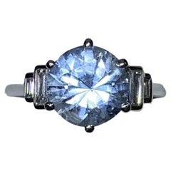 Aquamarine and emerald step diamond engagement ring in platinum.
