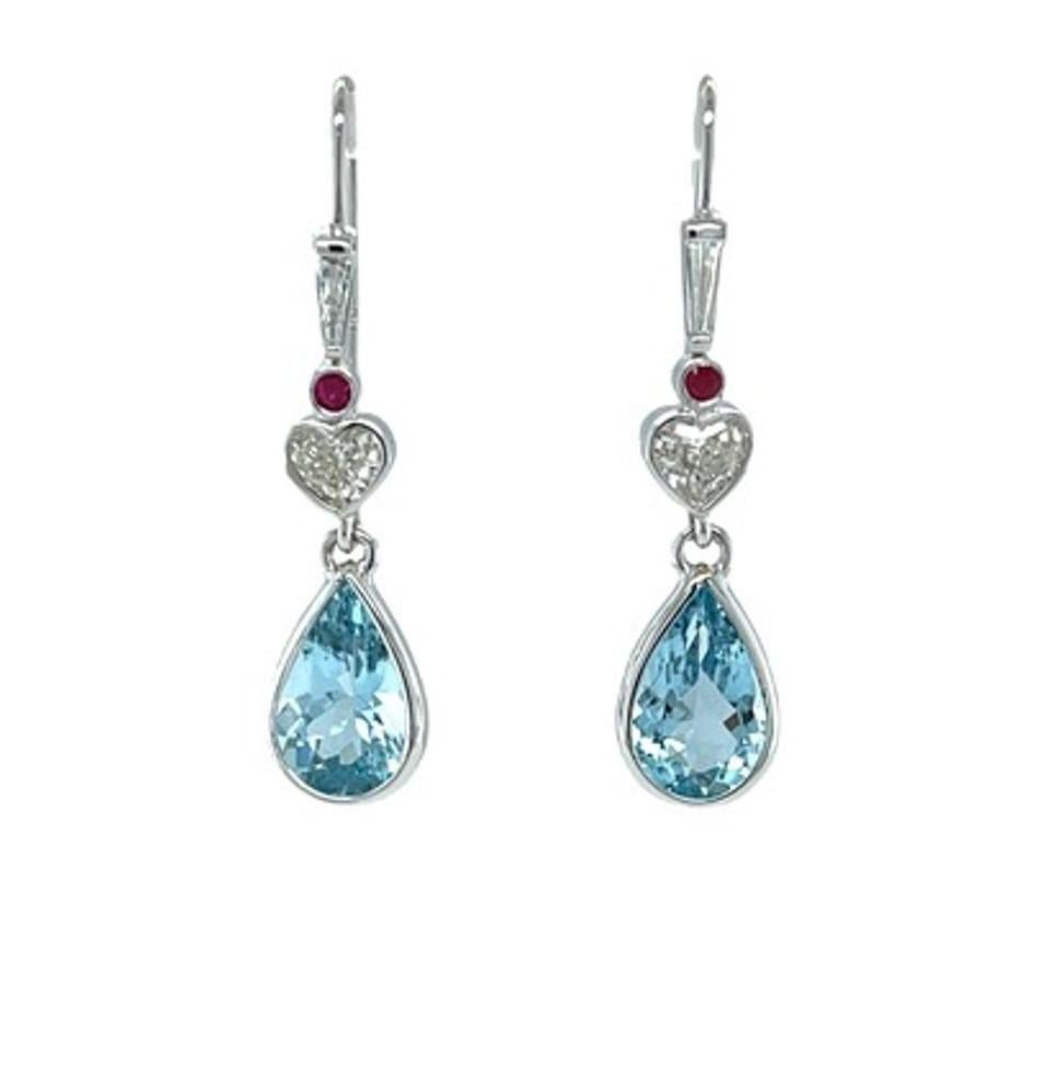 These beautiful earrings feature sparkling aquamarine drops that dangle playfully from two gorgeous heart-shaped diamonds, accented with rubies and diamond baguettes! The heart-shaped diamonds weigh half a carat combined, and have been bezel set in