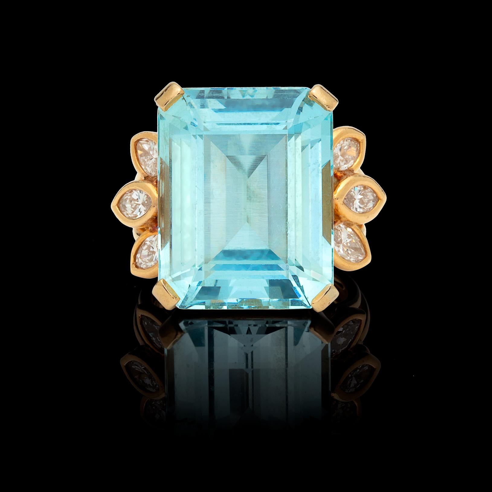 A bold and feminine design, the 18k yellow gold ring features a rectangular-cut aquamarine weighing approximately 19cts, decorated on each side with fans of 6 bezel-set marquise-cut diamonds, weighing in total an estimated 1.20cts. The ring weighs