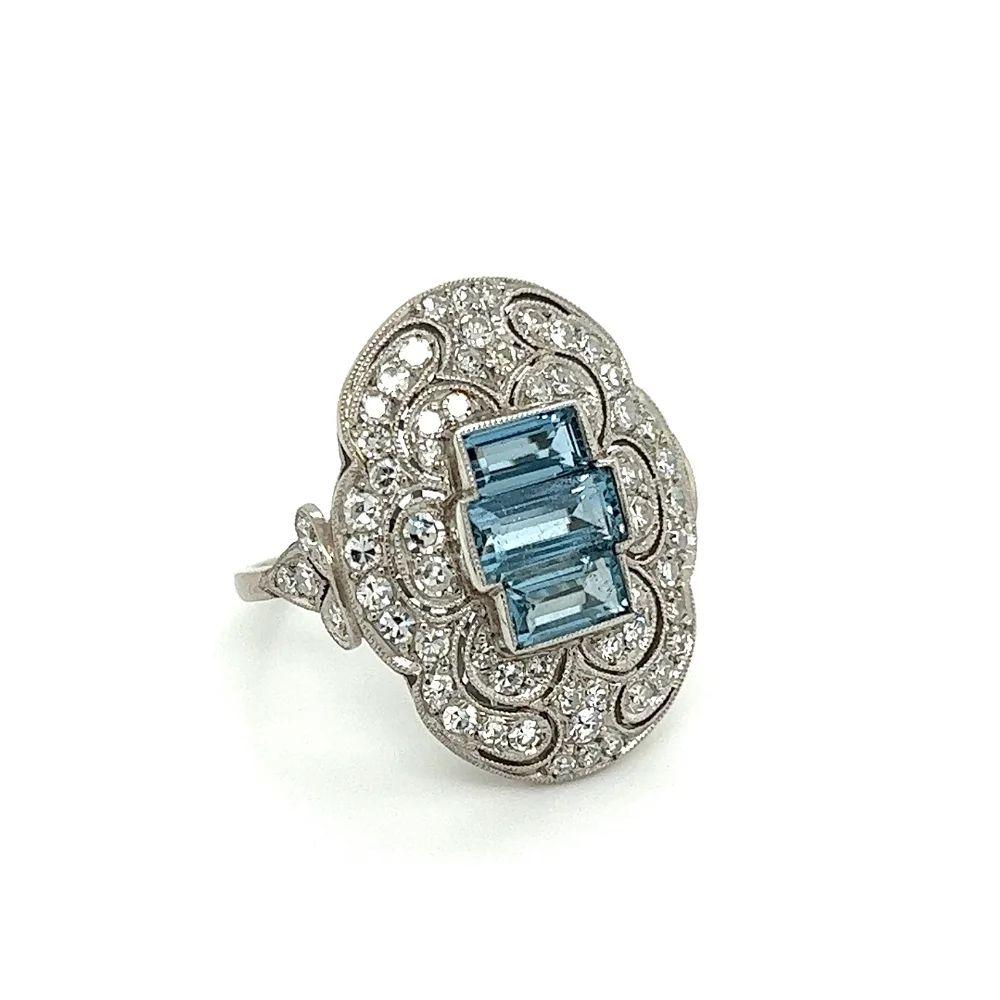Simply Beautiful! Elegant and finely detailed Aquamarine and Diamond Art Deco Revival Platinum Cocktail Ring. Centering securely nestled Aquamarines, weighing approx. 1.45tcw. Surrounded by OEC Diamonds, approx. 1.18tcw. The ring is Hand crafted in