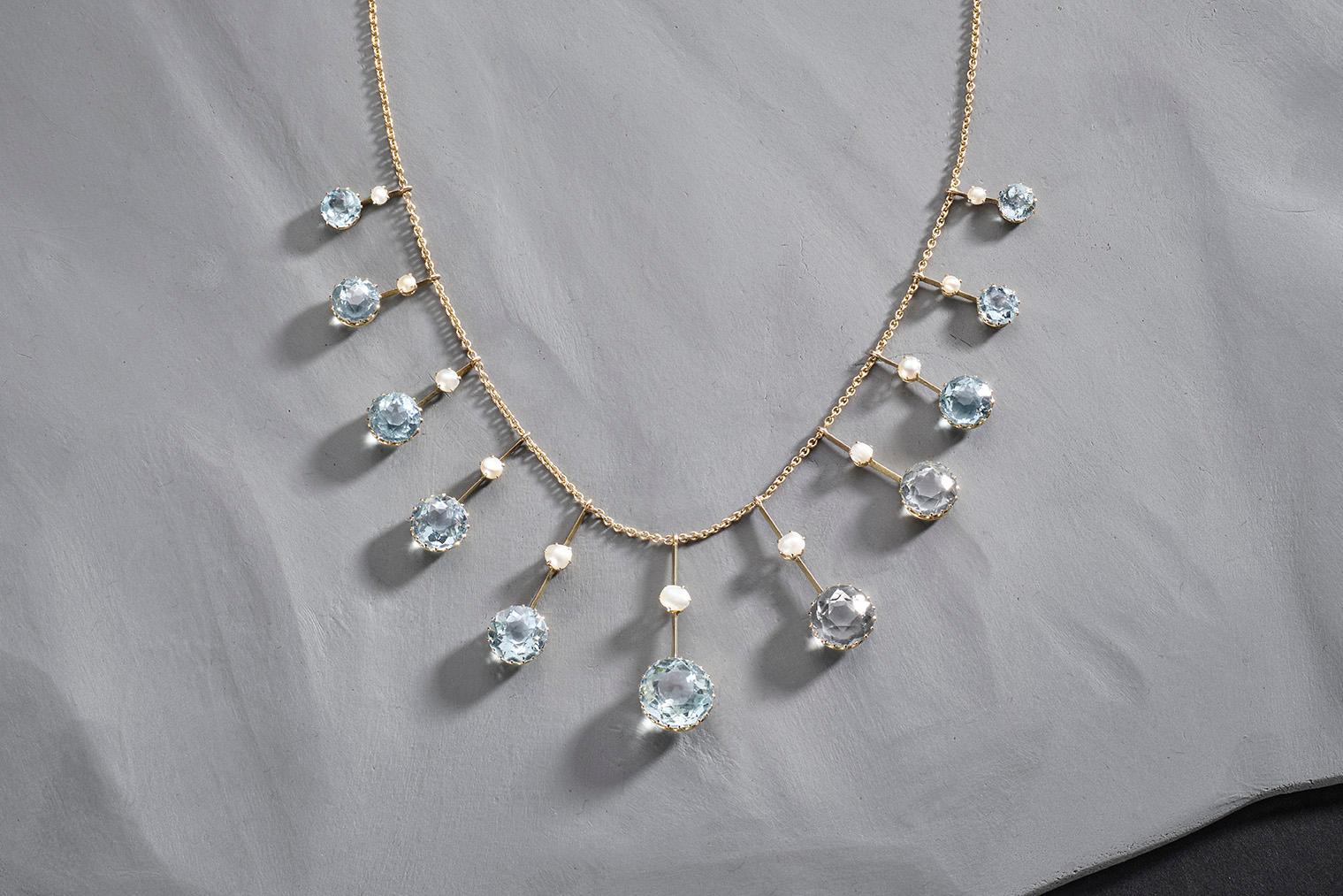 Diese edwardianische Halskette ist eine romantische Mischung aus Aquamarin, schimmernden Perlen und zartem Gold. In jedem zauberhaften Detail steckt zeitlose Eleganz. Diese Halskette sitzt hoch auf dem Schlüsselbein, wobei sich die beweglichen