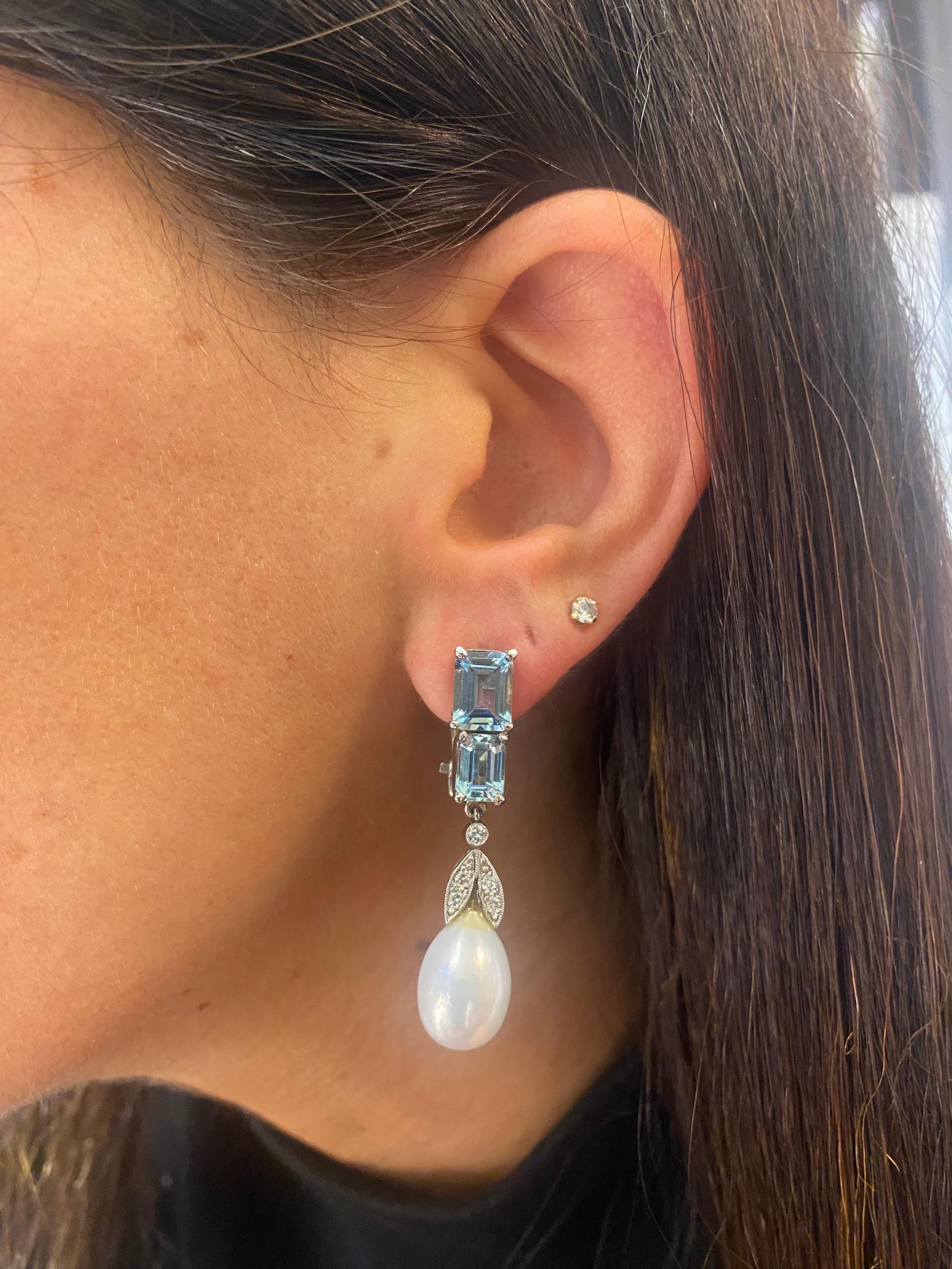 Aquamarine and Pearl Earrings

Emerald-cut aquamarine earrings with 2 cultured pearls, adorned with round cut diamonds. 

Approximate Aquamarine Weight: 4.23 carat 
Approximate Diamond Weight: .16 carats
Approximate Pearls Measurements: 9.4 - 13.3