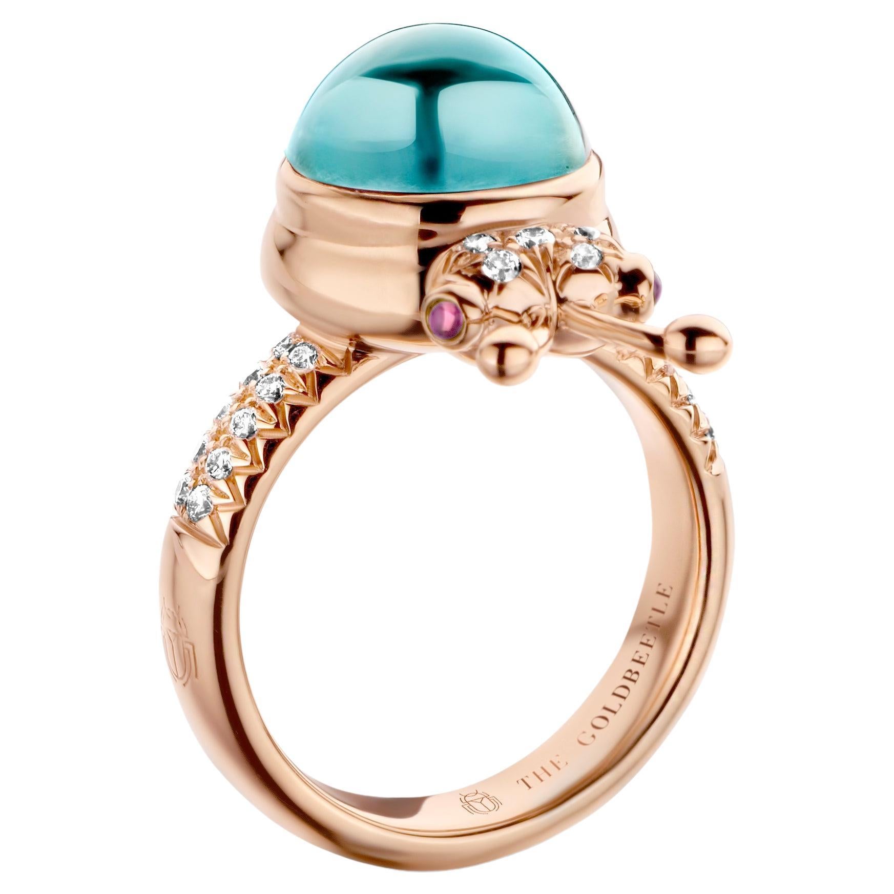 One-of-a-kind lucky beetle ring in 18 Karat rose gold 10g set with the finest natural diamonds in brilliant cut 0,23 Carat (VVS/DEF quality) one natural, Aquamarine in round cabochon cut 6,00 Carat and two pink tourmalines in round cabochon cut.