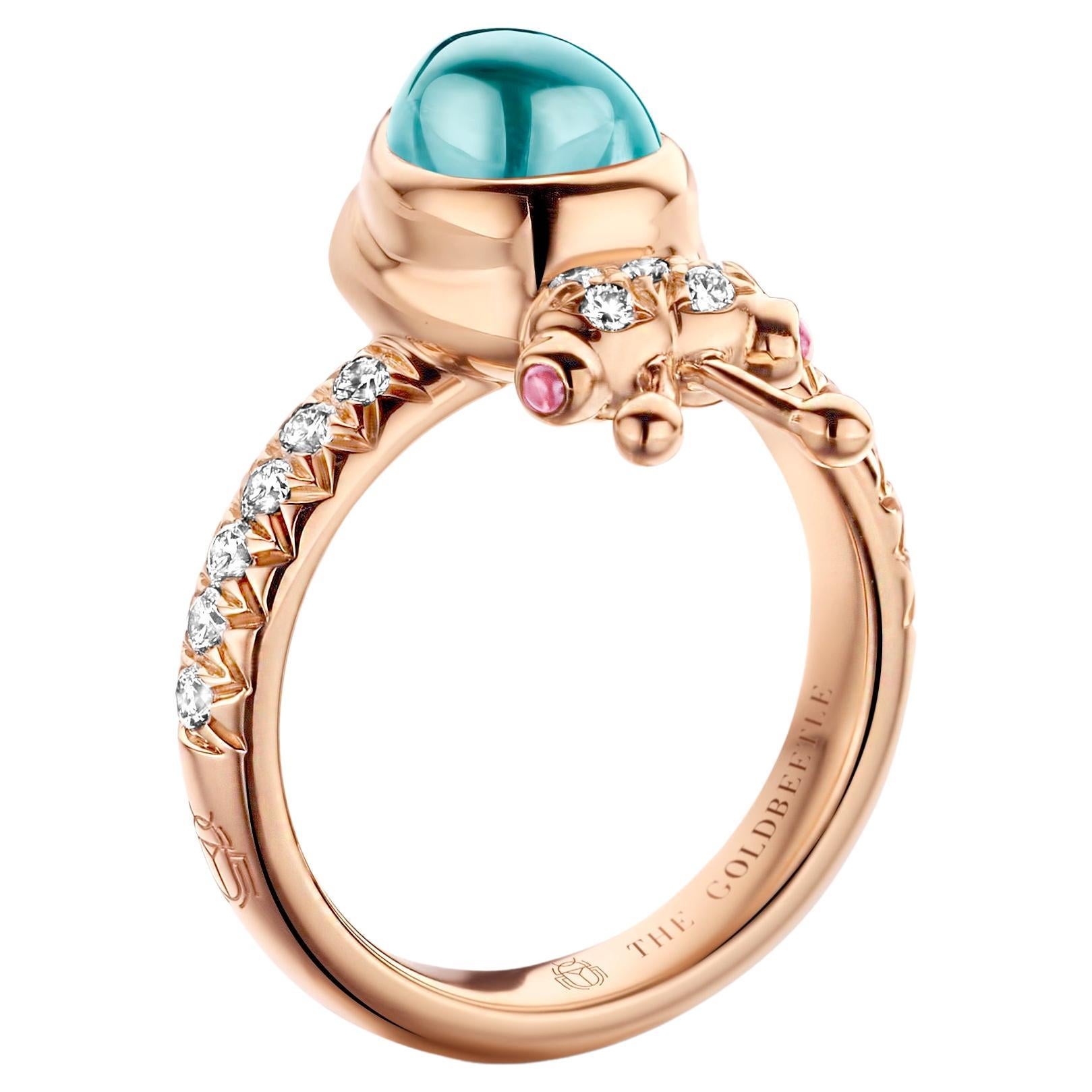 One-of-a-kind lucky beetle ring in 18 Karat rose gold 8,6 g set with the finest diamonds in brilliant cut 0,34 Carat (VVS/DEF quality) one natural, aquamarine in pear cabochon cut and two pink tourmalines in round cabochon cut.
Celine Roelens, a