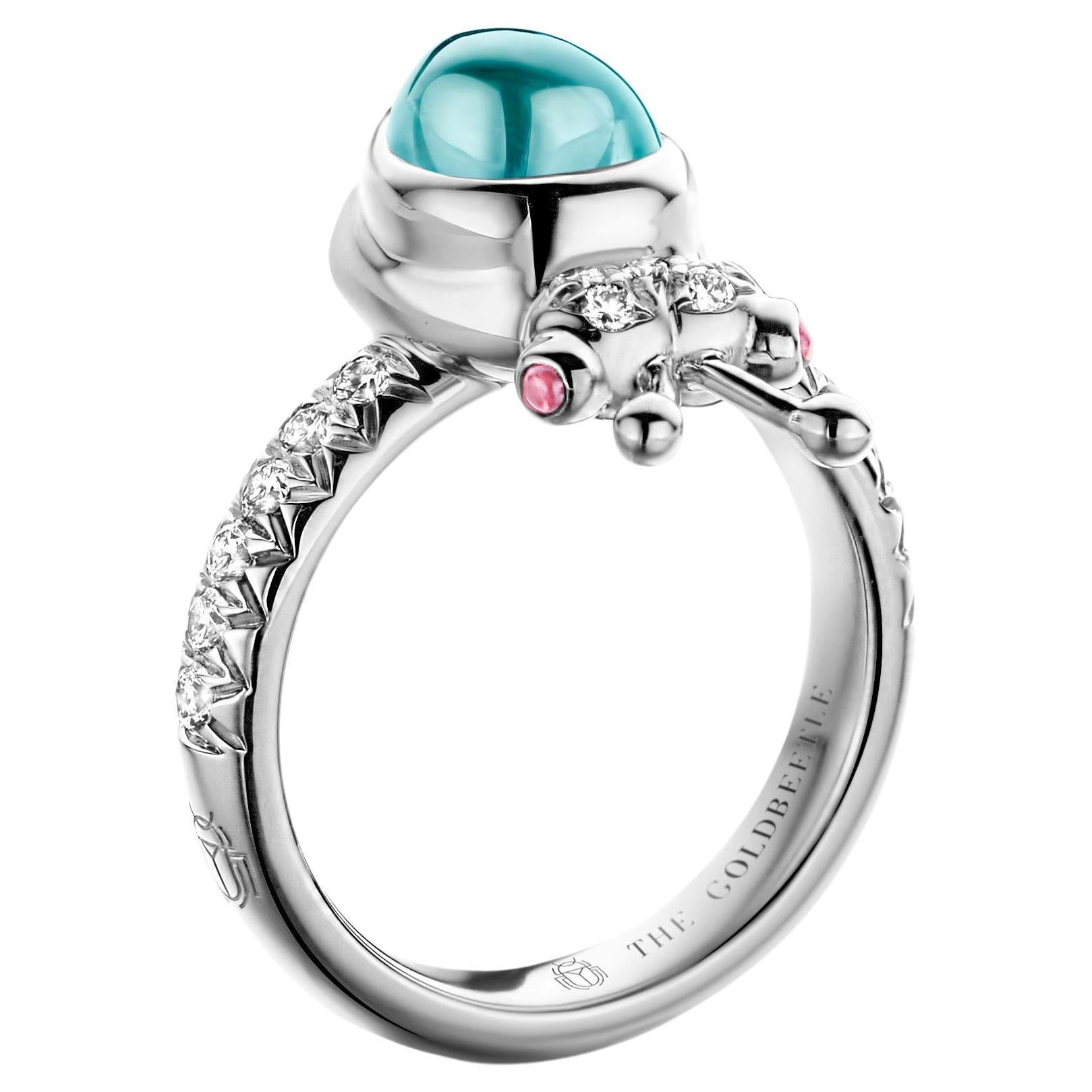 One-of-a-kind lucky beetle ring in 18-Karat white gold 8,6 g set with the finest diamonds in brilliant cut 0,34 Carat (VVS/DEF quality) one natural, aquamarine in pear cabochon cut and two pink tourmalines in round cabochon cut.
