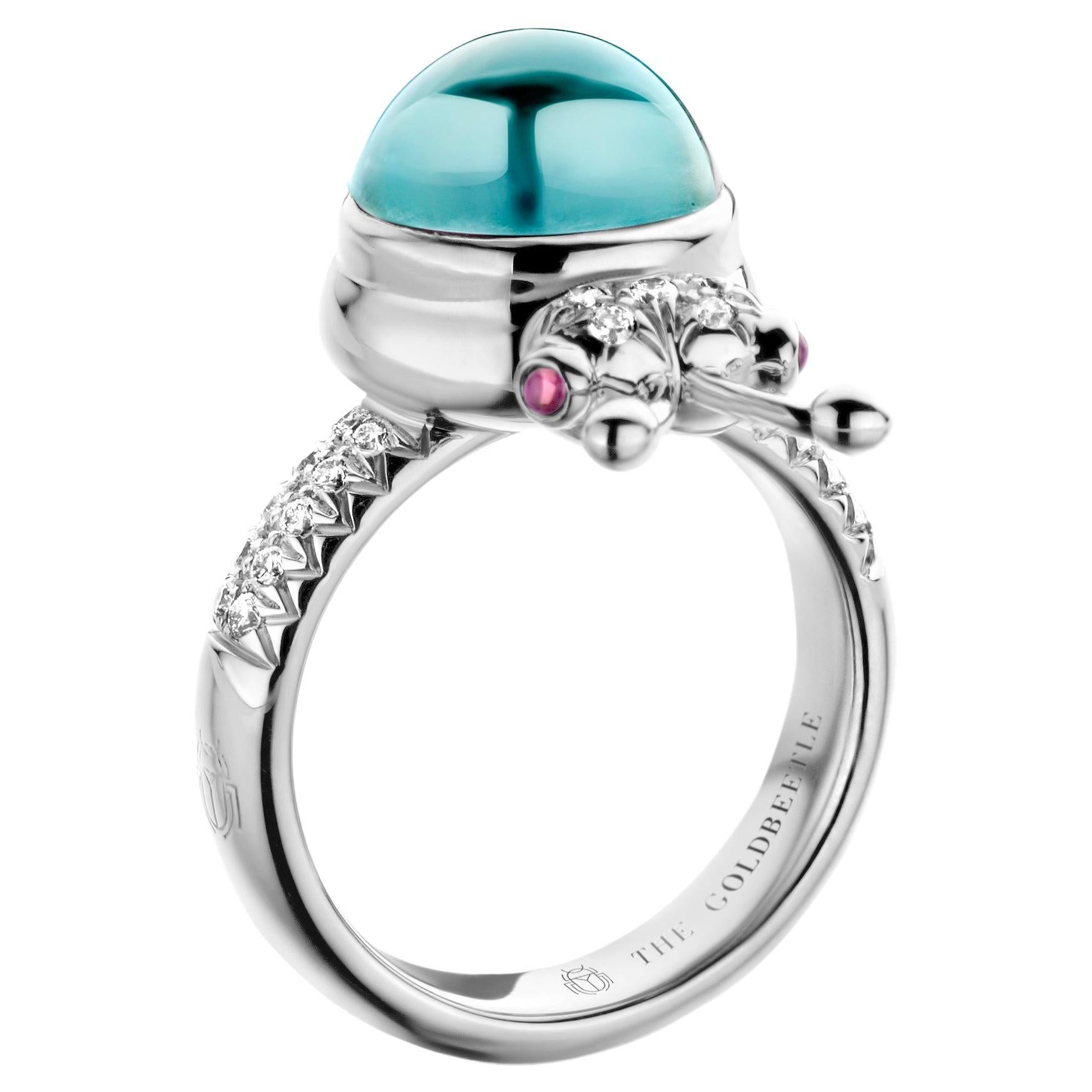 One-of-a-kind lucky beetle ring in 18-Karat white gold 10g set with the finest natural diamonds in brilliant cut 0,23 Carat (VVS/DEF quality) one natural, Aquamarine in round cabochon cut 6,00 Carat and two pink tourmalines in round cabochon cut.