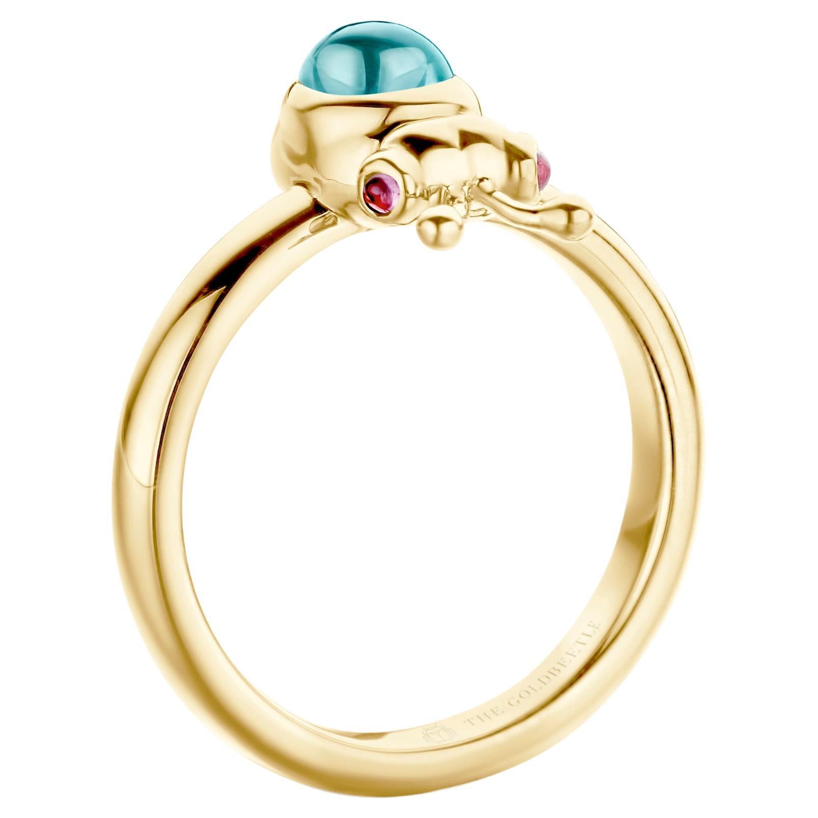 18-Karat yellow gold Lilou ring set with one natural aquamarine pear-shaped cabochon and two natural pink tourmalines in round cabochon cut.
Celine Roelens, a goldsmith and gemologist, specializes in unique, fine jewelry, handmade in Belgium and