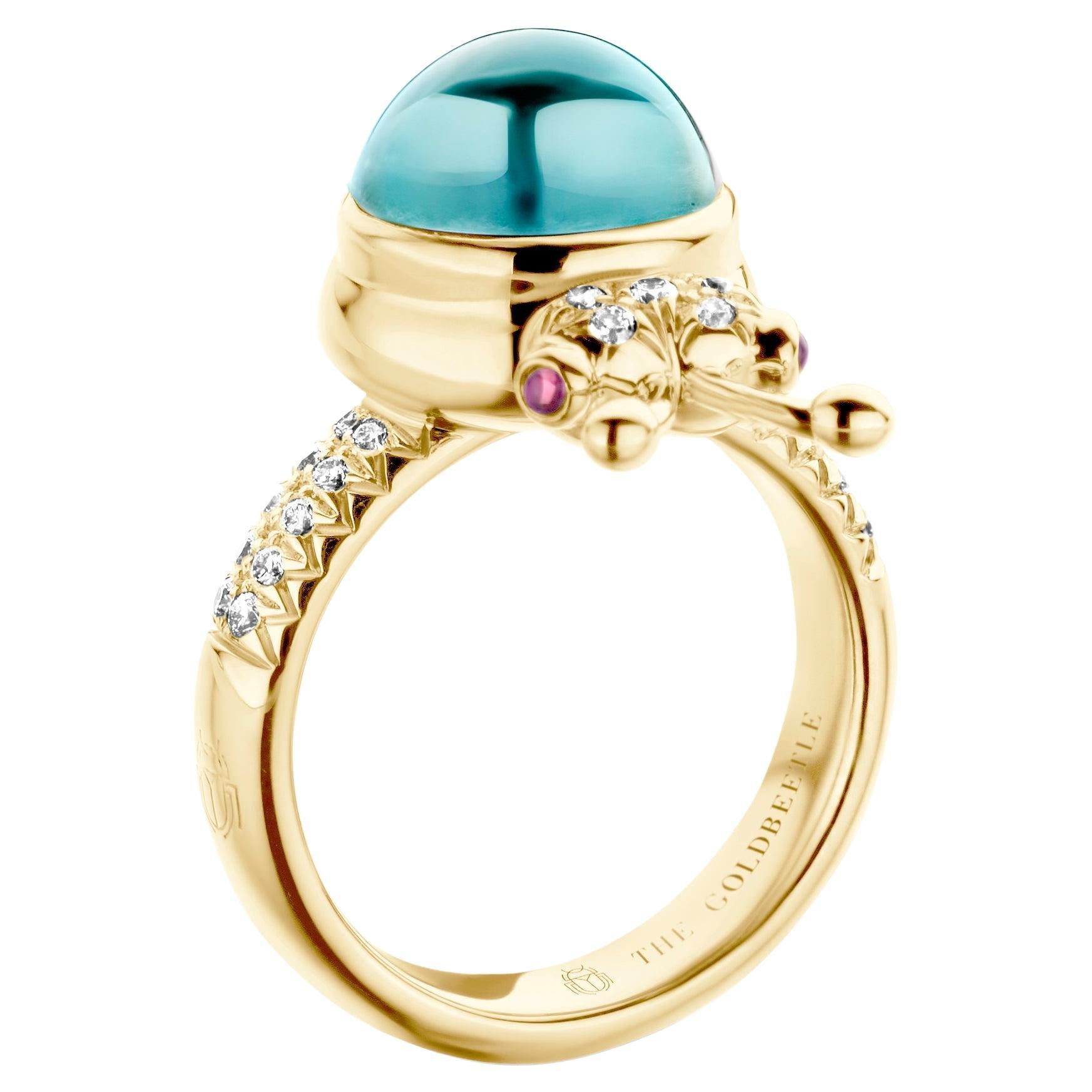 One-of-a-kind lucky beetle ring in 18-Karat yellow gold 10g set with the finest natural diamonds in brilliant cut 0,23 Carat (VVS/DEF quality) one natural, Aquamarine in round cabochon cut 6,00 Carat and two pink tourmalines in round cabochon cut.