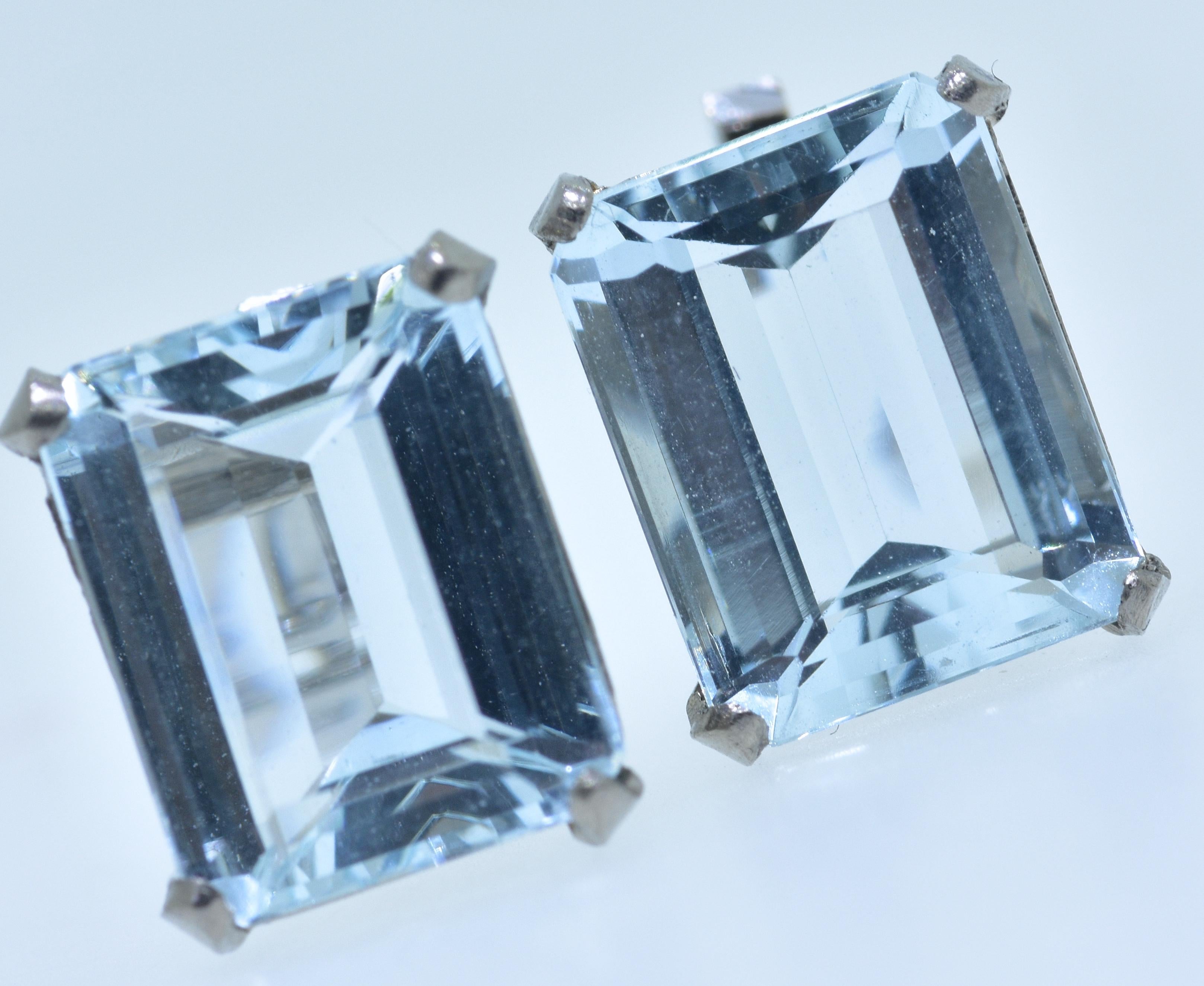 Platinum earrings possessing emerald cut natural light blue aquamarines.  These pastel blue natural aquamarines measure 10.9 mm by 8.6 mm and 4.9 mm, they are estimated to weigh conservatively 6 cts.  They are well match and very clean and set well