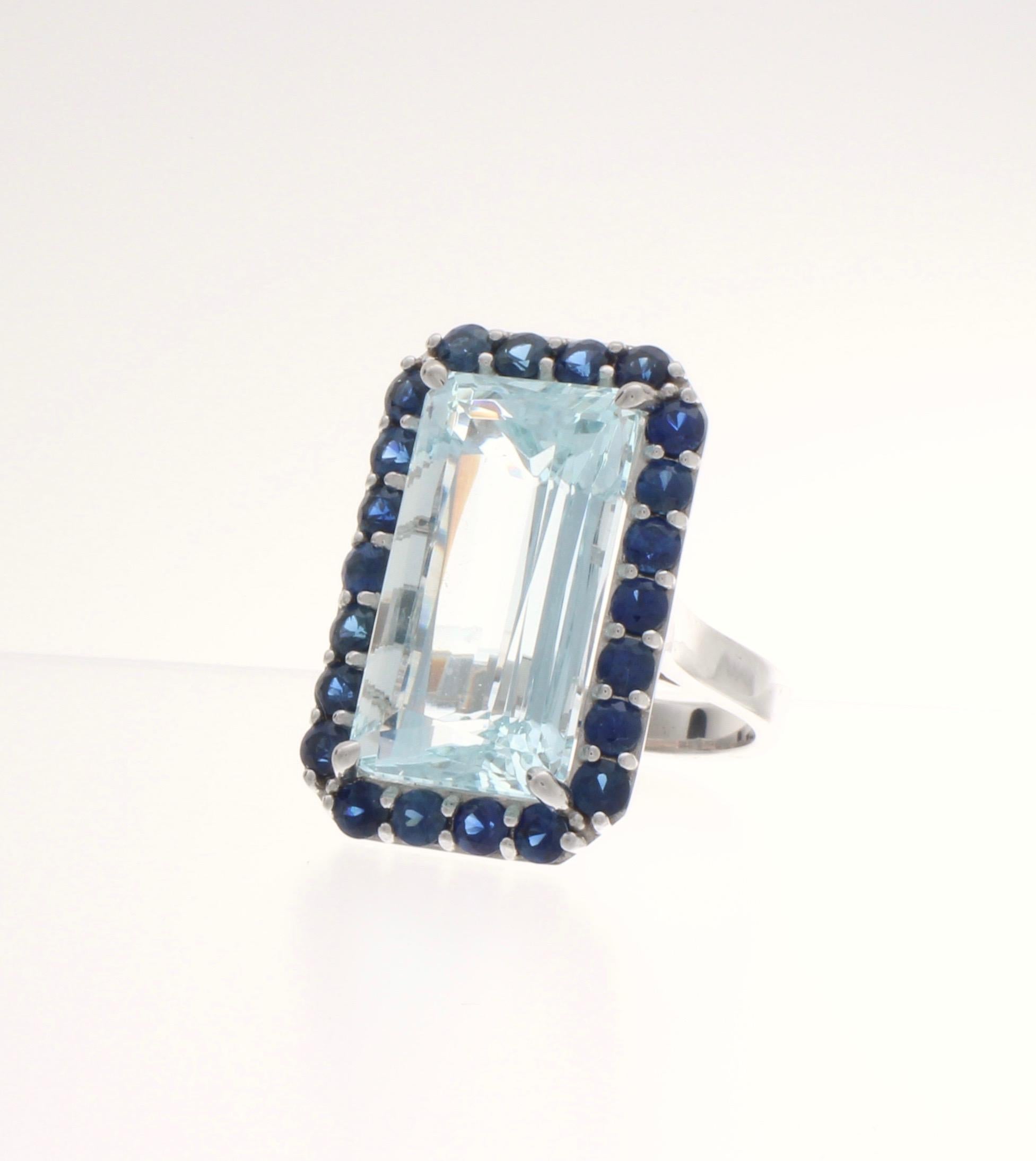 21 Carat emerald cut Aquamarine set with 23 AAA grade blue sapphires in solid 14 karat white gold.  One of a kind.
