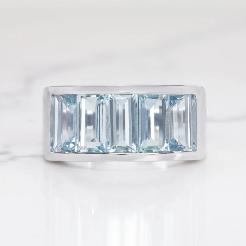 gorgeous aquamarine and 14k white gold ring is effortlessly elegant! The aquamarines are a serene and stylish sky blue color. Set in a simple, clean, and elegant channel, the sapphires create a gorgeous row of continual sparkle. The baguette cuts