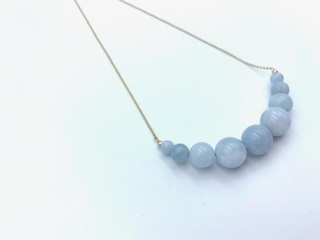 Hand made using 9 carat Yellow Gold, the suspended Aquamarine beads are threaded together with a solid gold wire and graduated onto a delicate 1.3 mm cable chain. The lovely soft blue centre bead is 12 mm in size, 10mm the two following, 8 mm the