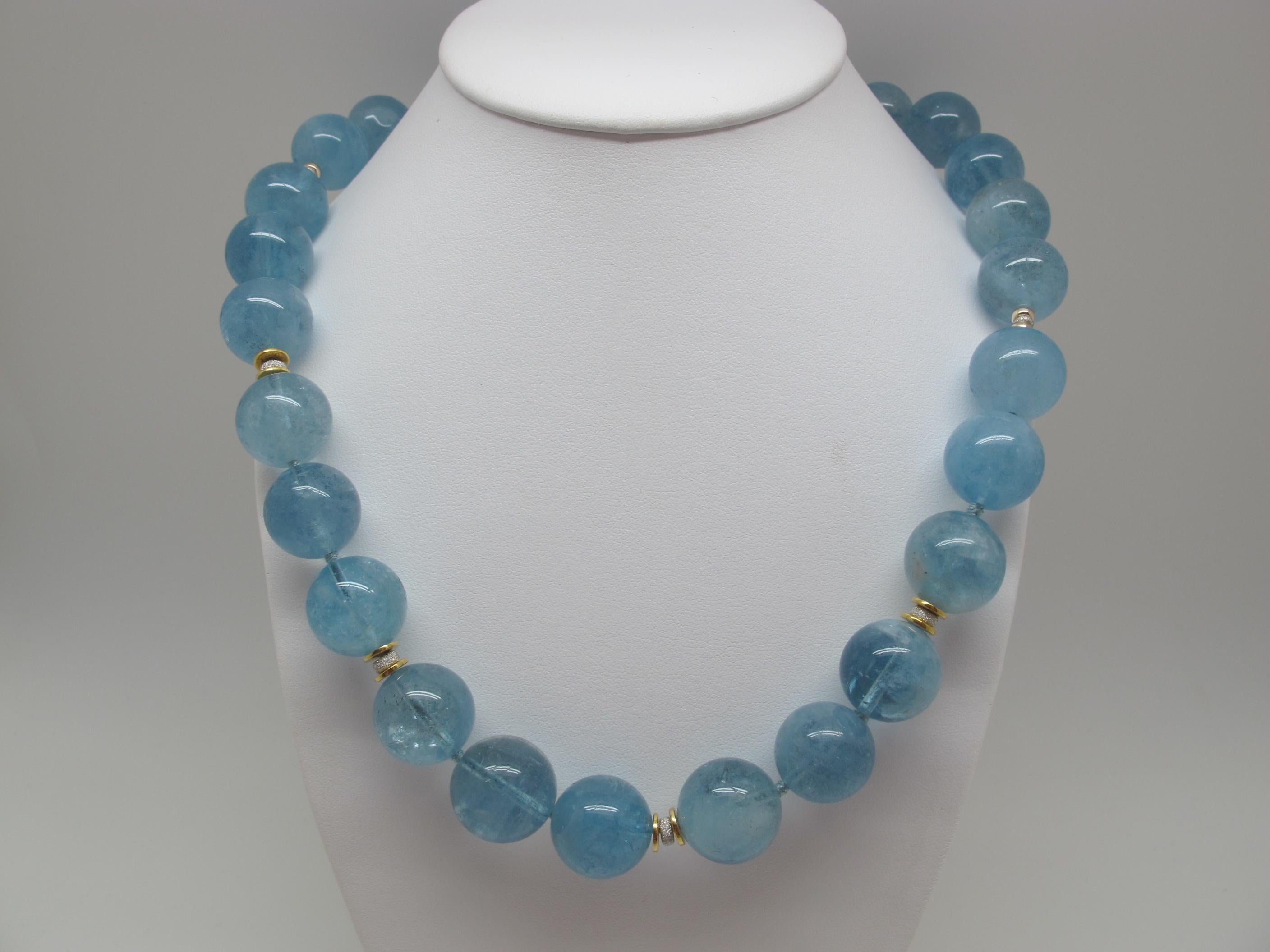 This simply stunning aquamarine beaded necklace is the perfect addition to any jewelry collection. The 16 millimeter vibrant aquamarine beads are extremely high quality and rare. The bright 14K and 22K yellow gold spacers elevate this piece to new