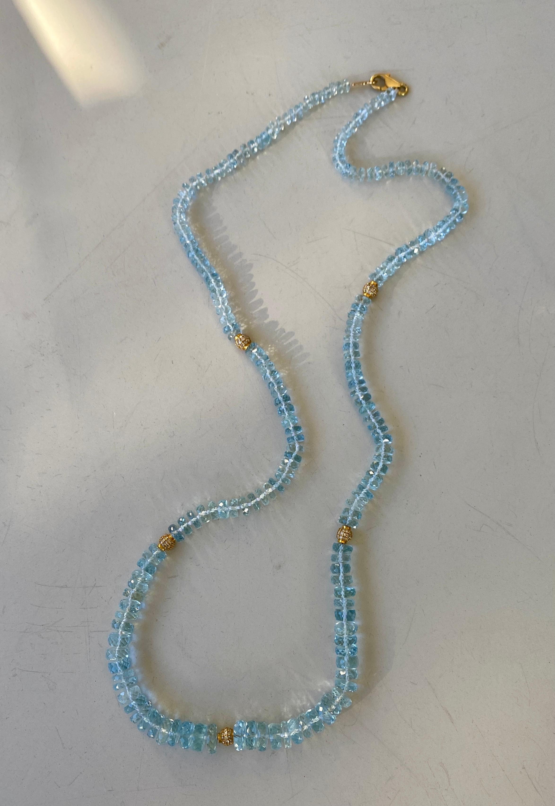 Faceted aquamarine bead necklace with five diamond spacers in 14 karat yellow gold and a clasp in 18 karat yellow gold, length of 24.5 inches.

This beautifully brilliant necklace of fine faceted aquamarine beads, accented by five diamond spacers,
