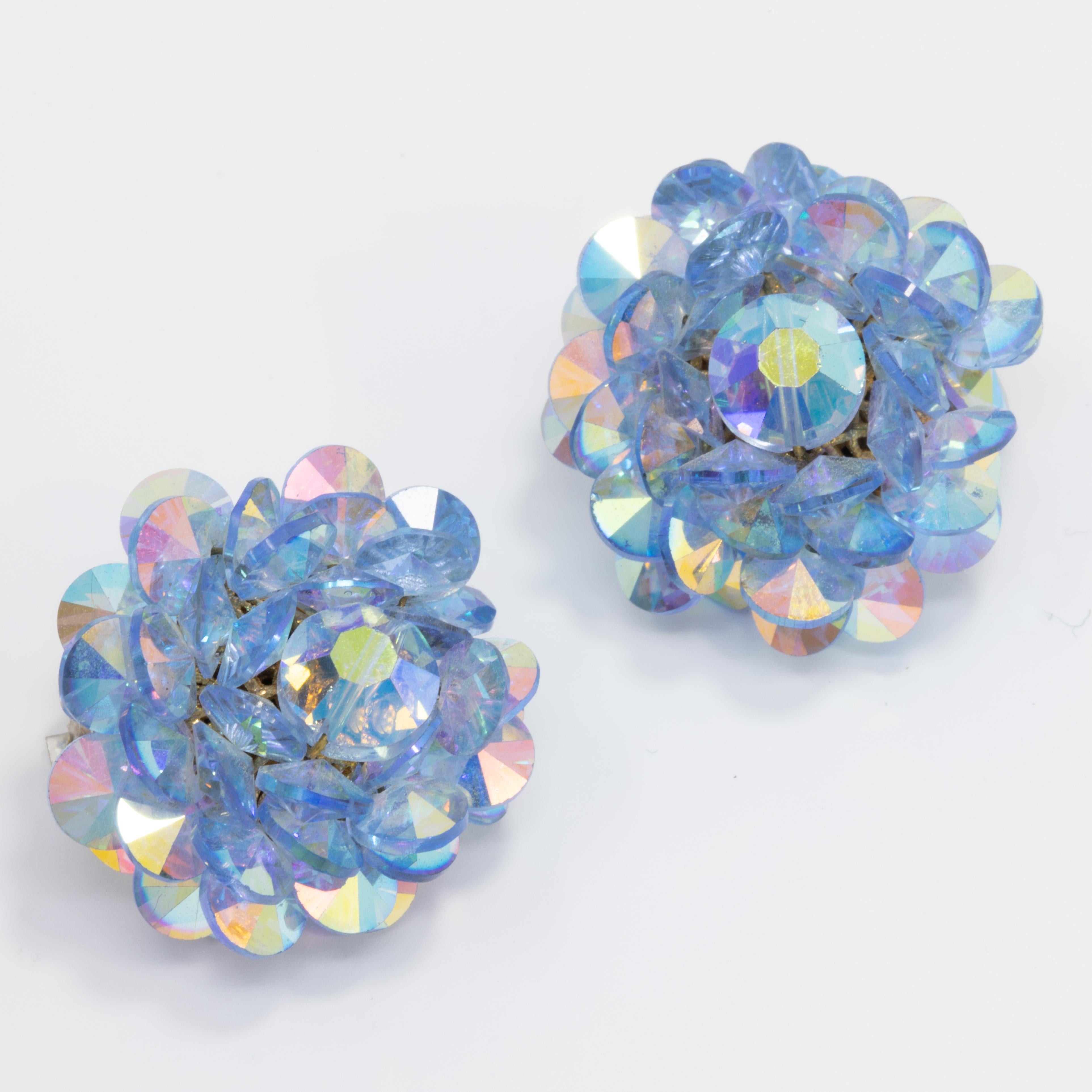 Glowing pair of vintage earrings, with clusters of aquamarine crystals with an aurora borealis tint. Set on silver-tone clips.

Vintage, like-new. Wonderfully preserved.