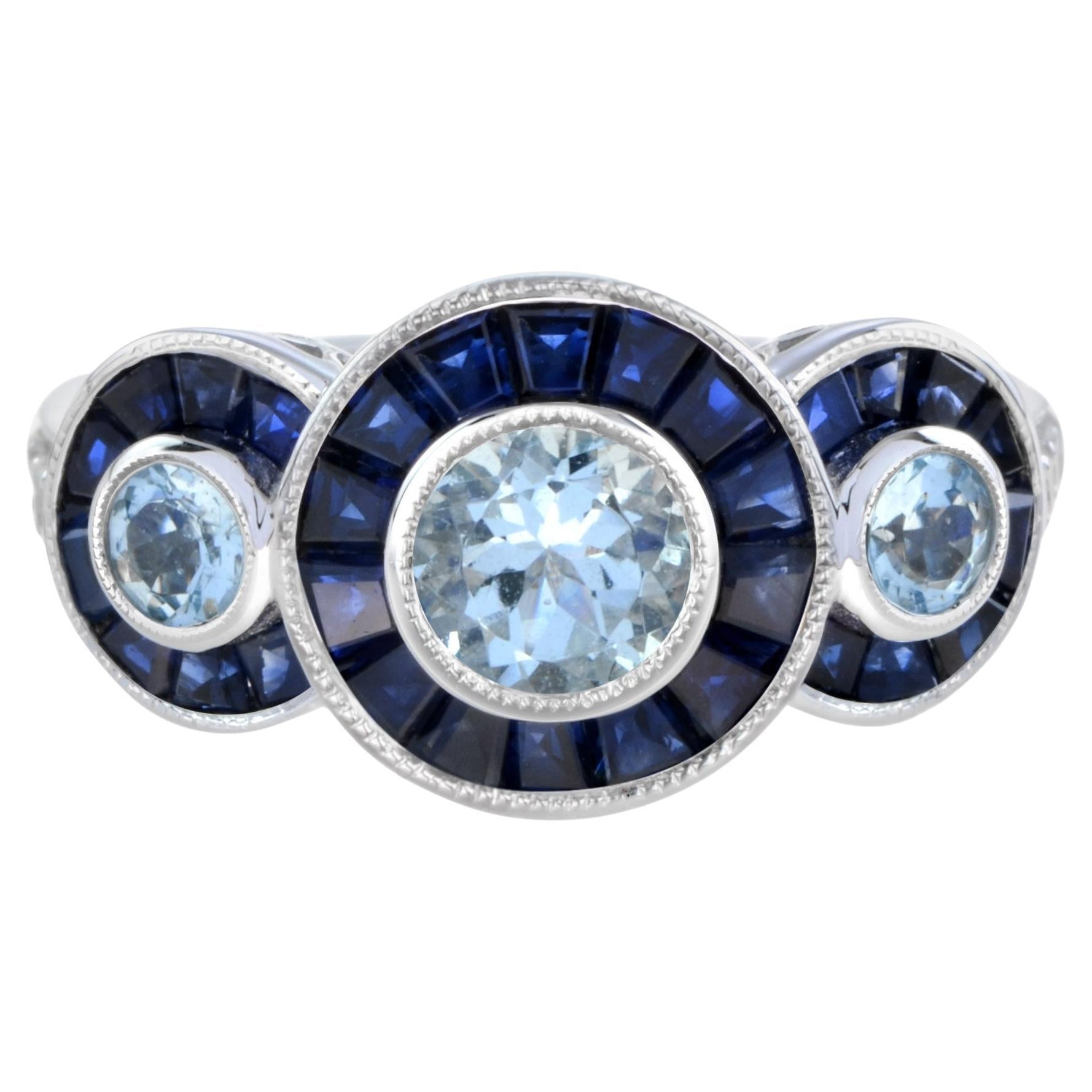 Anillo de oro de tres piedras estilo Art Déco con aguamarina, zafiro azul y halo de diamantes en venta