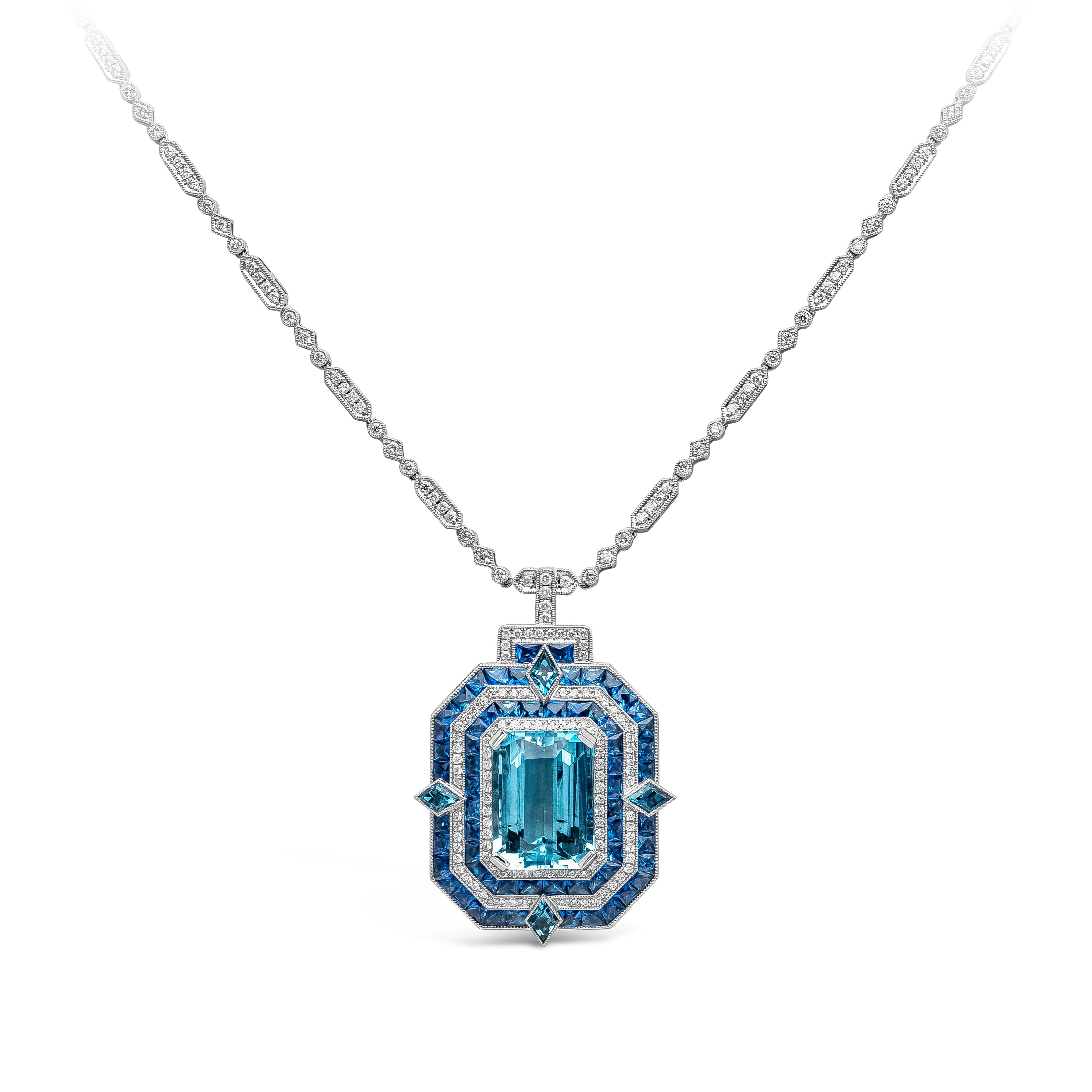 A beautiful and a statement piece of jewelry showcasing a 9.00 carat emerald cut aquamarine, accented by vibrant blue sapphires, kite cut London topaz, and round brilliant diamonds. The gemstones are set in an intricately-designed pendant and