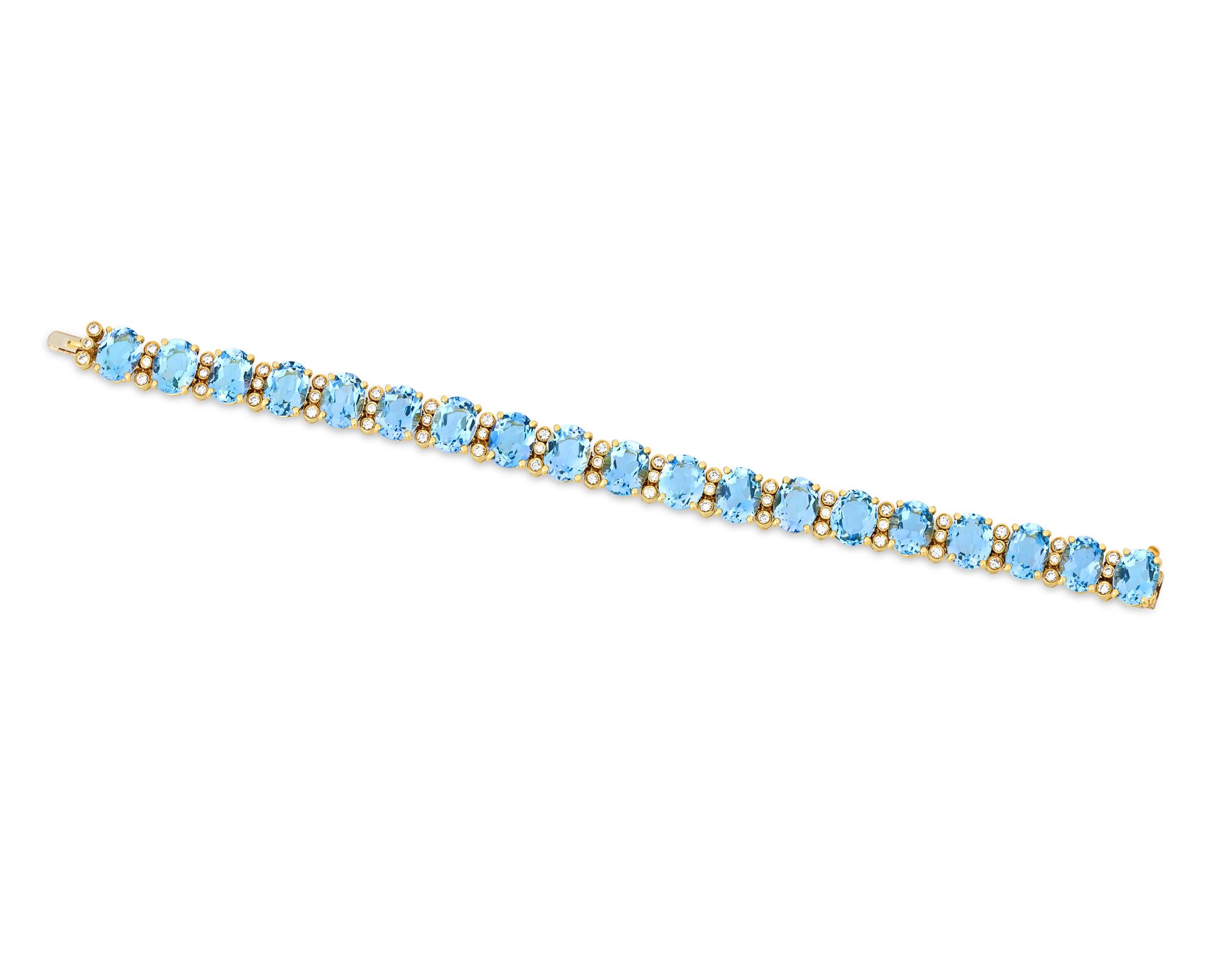 A dazzling sight to behold, this luminous aquamarine bracelet features 19 of exceptional blue gemstones arranged in a line. Totaling approximately 30.00 carats, the ocean-hued jewels are accented by sparkling white diamonds totaling approximately