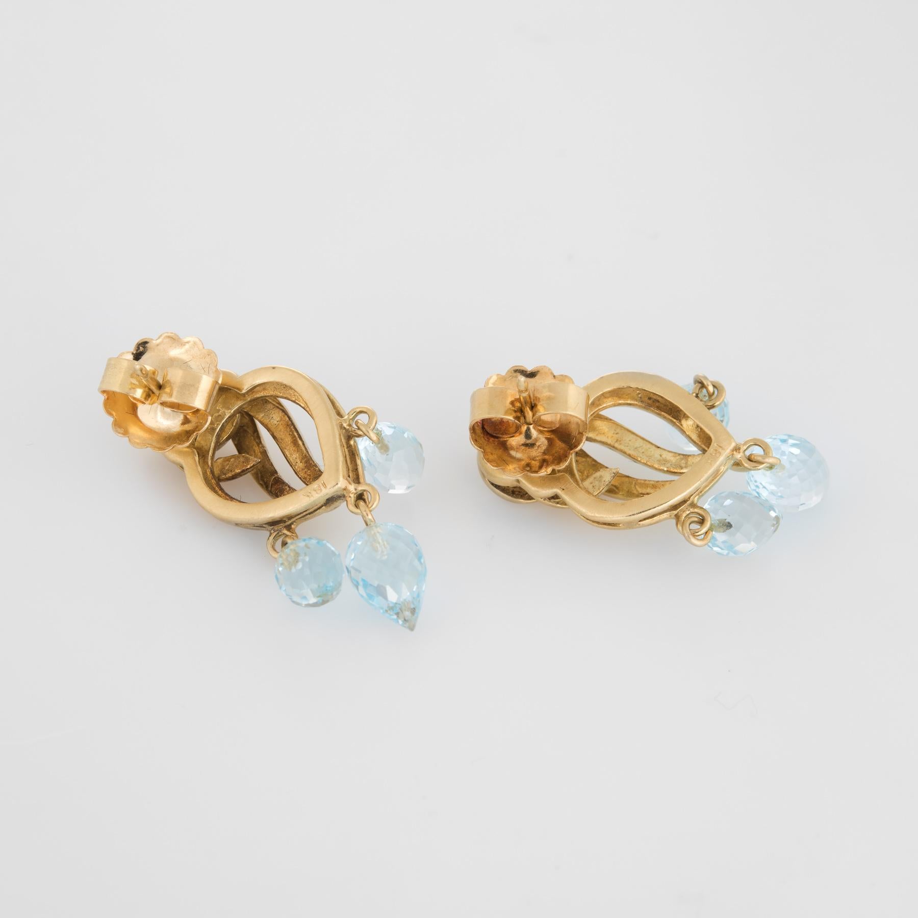 Finely detailed pair of estate aquamarine drop earrings, crafted in 18k yellow gold. 

Six aquamarine briolette's graduate in size from 7mm x 5mm to 9mm x 5mm. The aquamarines are in excellent condition and free of cracks or chips.  

The charming