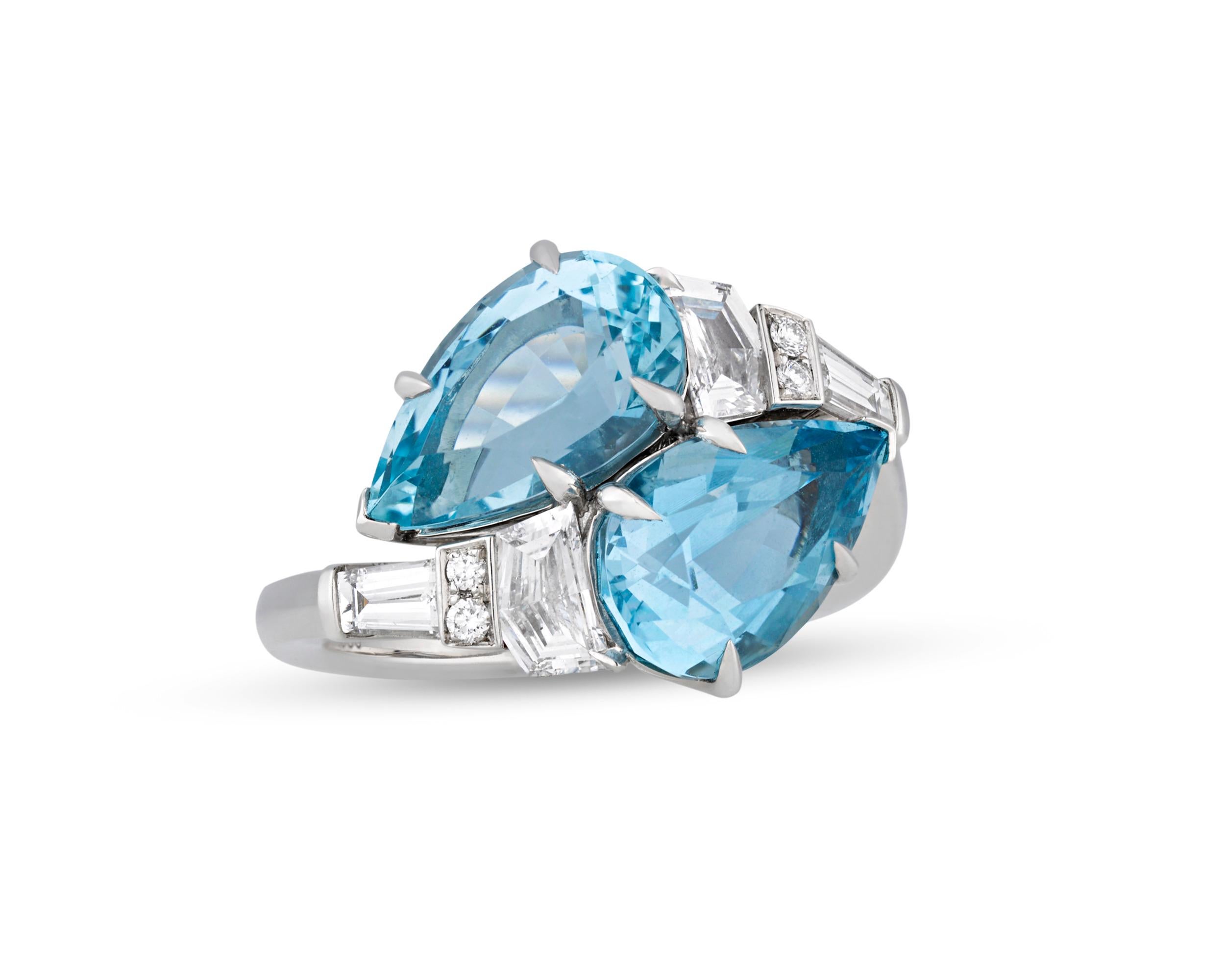 Legendary American jeweler and designer Raymond Yard created this spectacular bypass ring starring two vibrant pear-shaped aquamarines totaling 4.64 carats. The enchanting gems display the refreshing, crisp blue color for which they are so coveted.