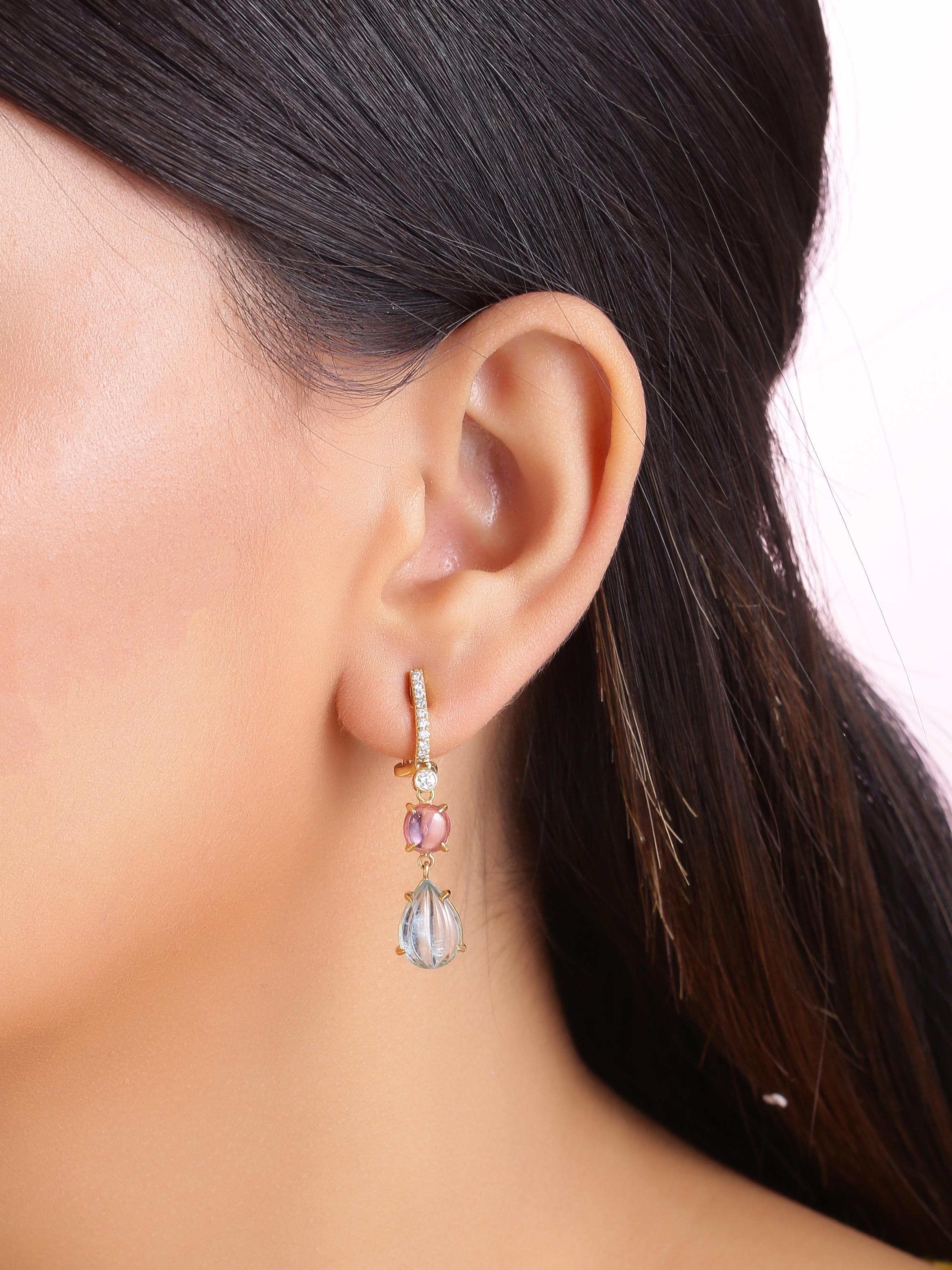 A pair of beautiful light weight dangle earrings with a diamond hoop on top then a pair of Natural Pink Spinel Cabochon followed by a pair of fine hand carved Aquamarines. 
The piece is made in 18K yellow gold.

The aquamarines in the earrings weigh