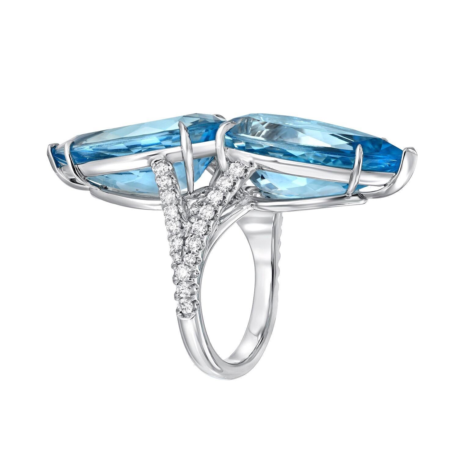 Incredible pair of vivid blue Aquamarine pear shapes, weighing a total of 18.59 carats, and a total of 0.80 carats of round brilliant diamonds, are set together to compose this magnificent hand crafted platinum diamond ring.
Size 6. Resizing is