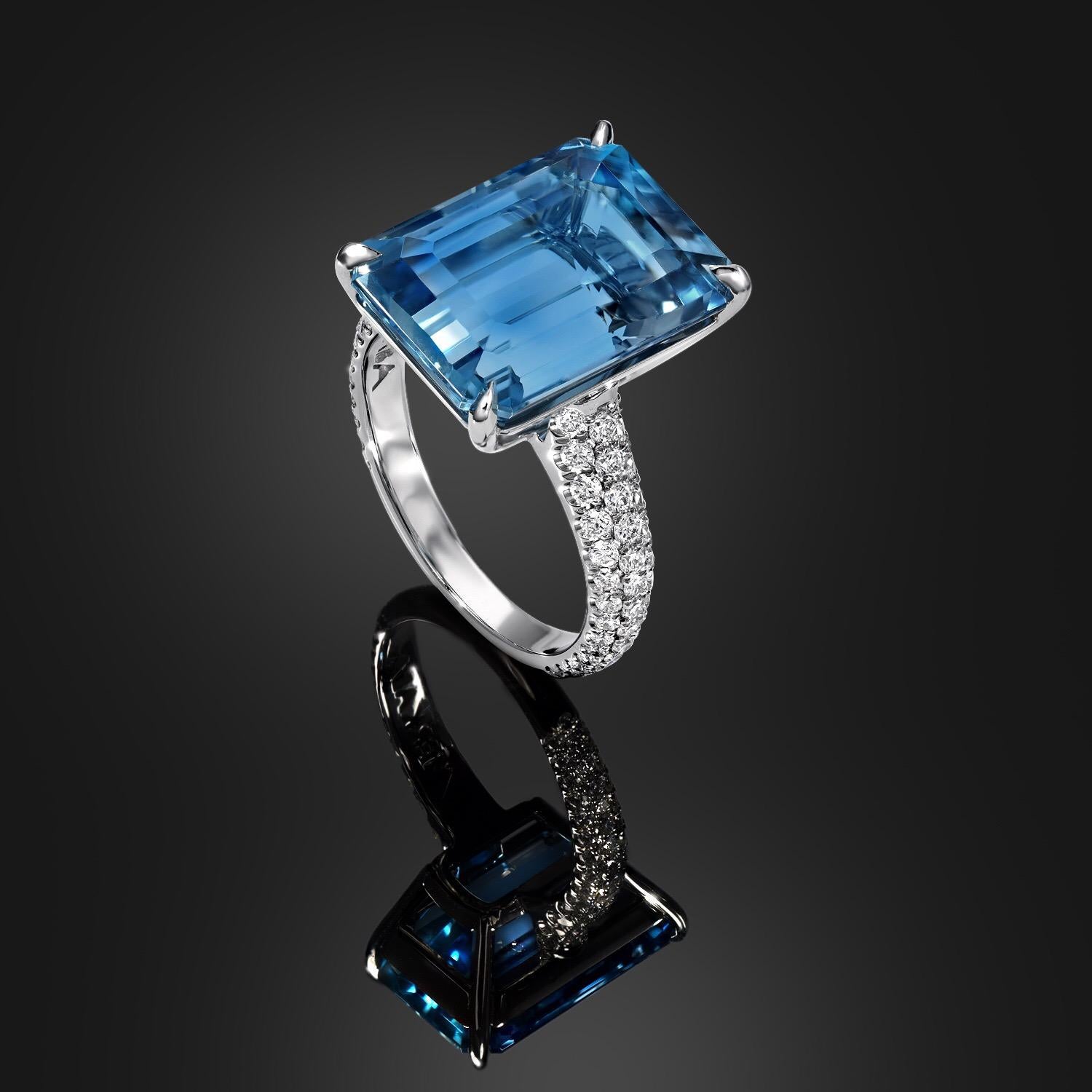 Vivid blue Aquamarine emerald cut, weighing a total of 9.59 carats, hand set in a magnificent platinum ring, adorned by a total of 0.88 carats total of round brilliant diamonds, set in a three row shank.
Aquamarines of this color, cut and clarity