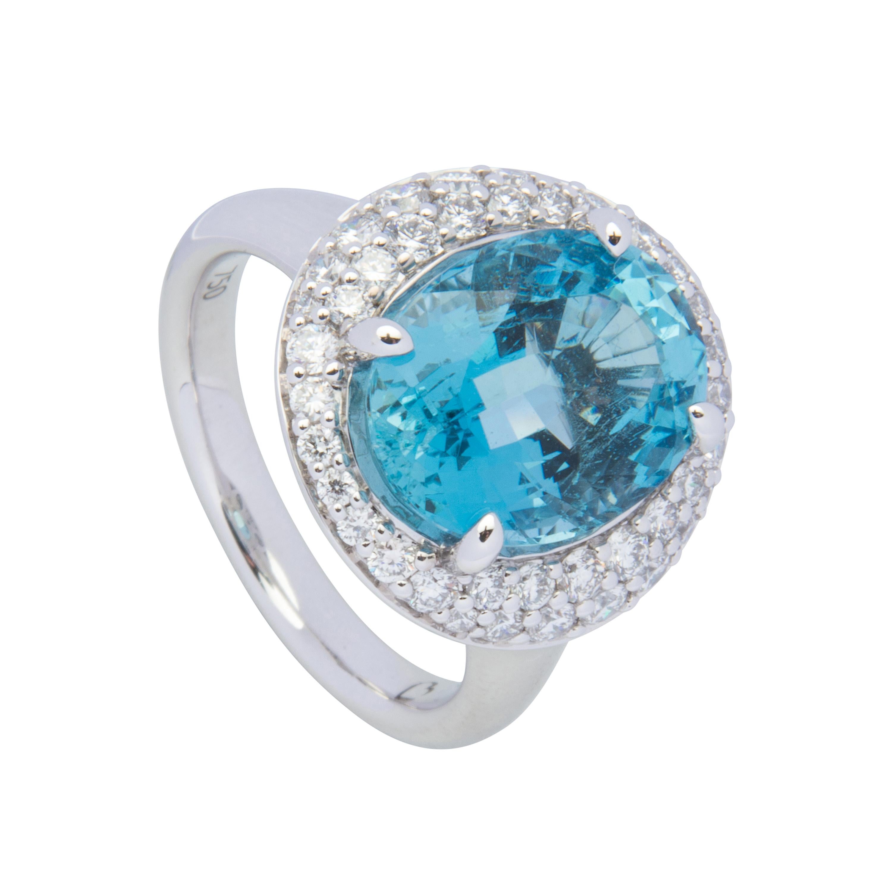 18 karat white gold cocktail ring featuring oval shape aquamarine 5.36ct and round brilliant cut diamonds totalling 0.81ct.  Size US6.5, sizeable +2 or -2.