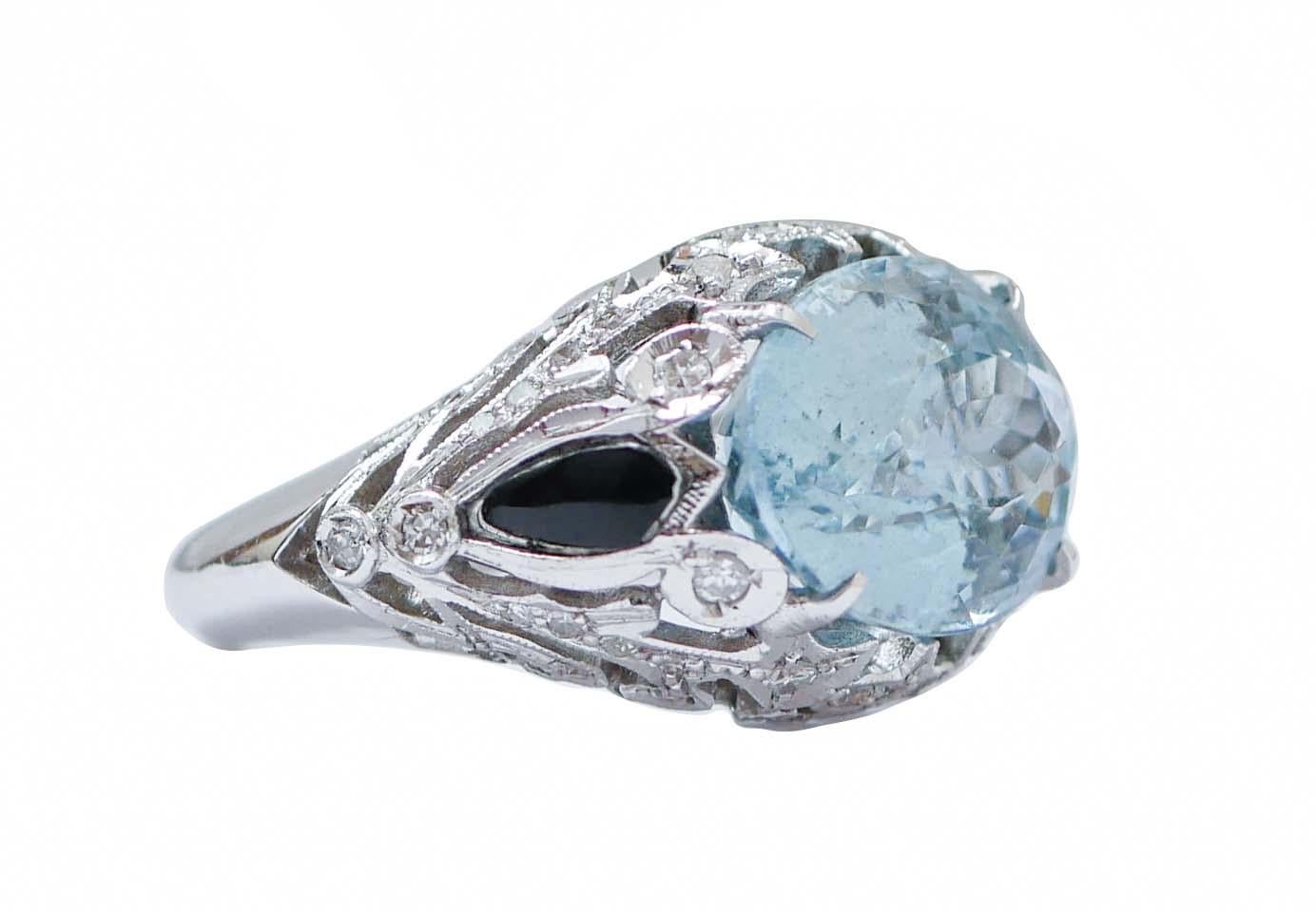Fantastic ring in 14 kt white gold structure mounted with a central topaz surrounded by diamonds and,laterally, an onyx.
This ring was totally handmade by Italian master goldsmiths and it is in perfect conditions.
Diamonds 0.64 ct
Topaz 8.20 ct
Onyx