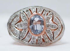 Anillo con topacio color aguamarina, diamantes, oro rosa y plata