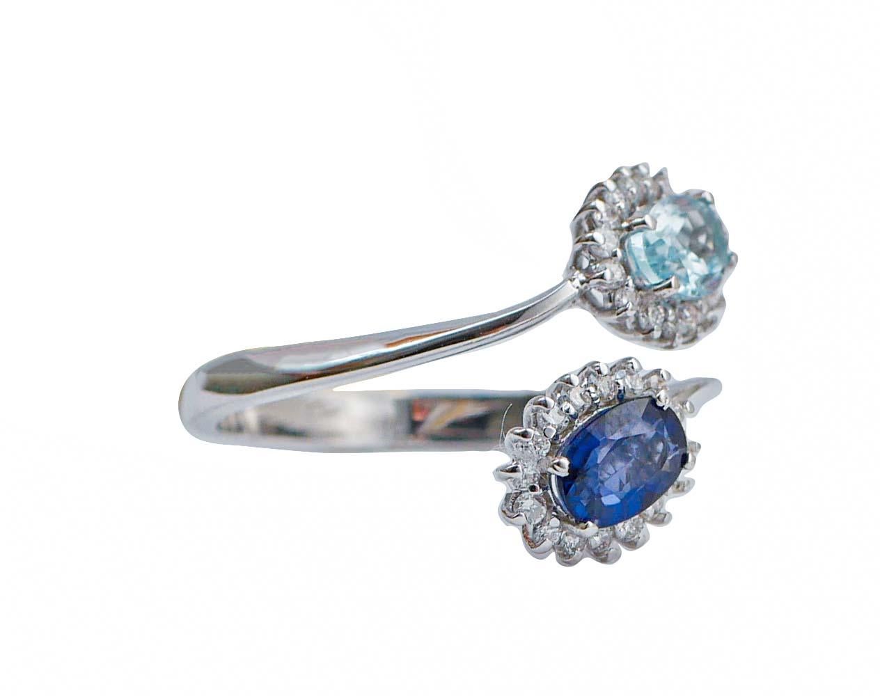 Elegant modern ring in 18 kt white gold structure mounted with a topaz and a sapphire surrounded by diamonds.
Diamonds 0.34 ct
Sapphire 0.66 ct
Topaz 0.62 ct
Total Weight 3.40 gr
RF       G      GOEI
Italian Size 15
Usa Size  7.17
French Size  