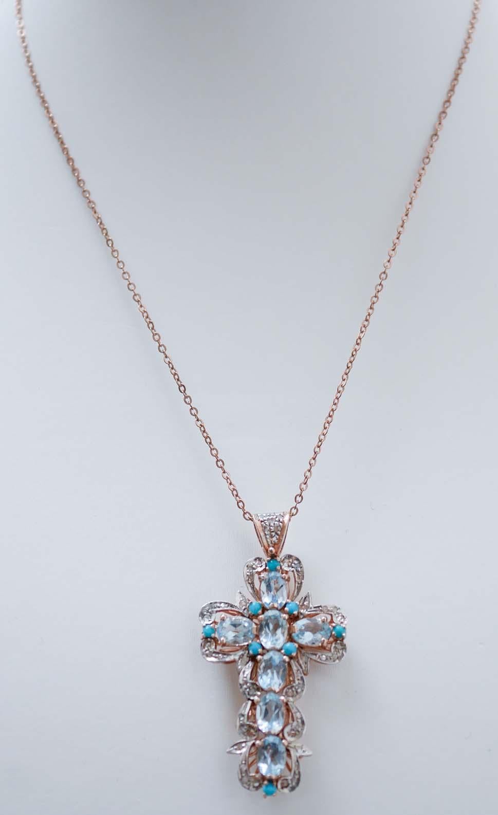 Fantastic cross pendant in 9 kt rose gold and silver structure mounted with topaz surrounded by diamonds and little turquoise. The silver chain is included
This pendant was totally handmade by Italian master goldsmiths and it is in perfect