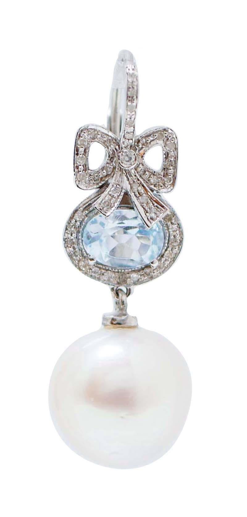 Beautiful earrings in 14 kt white gold structure mounted with a flake of diamonds and, below, a topaz surrounded by diamonds. As pendant, a white pearl.
These earrings were totally handmade by Italian master goldsmiths and they are in perfect