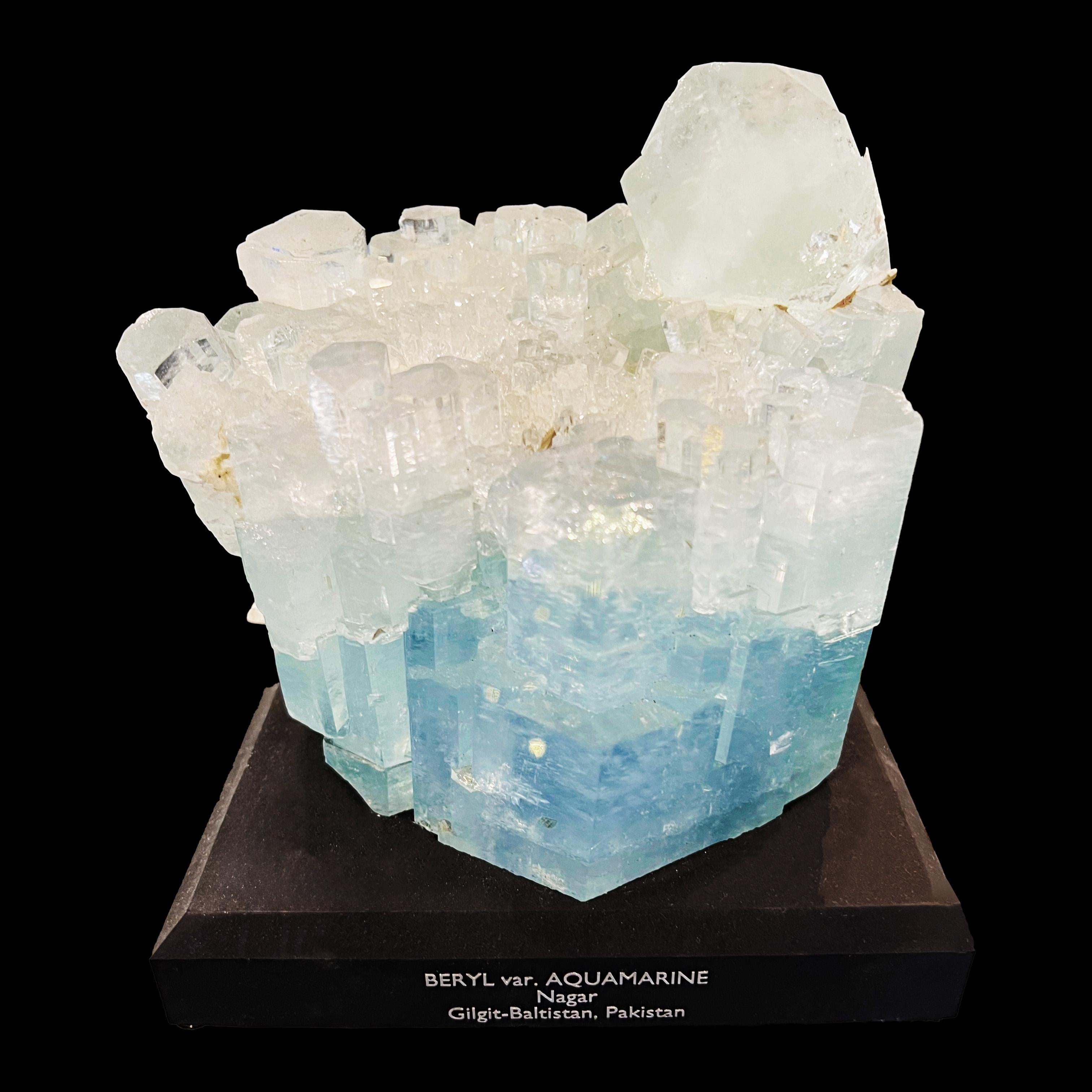 This striking, delicately hued sky blue aquamarine specimen features a cluster of incredibly clear, perfect terminations of varying sizes accented with scattered pieces of lustrous muscovite for a uniquely dynamic piece out of Nagar in