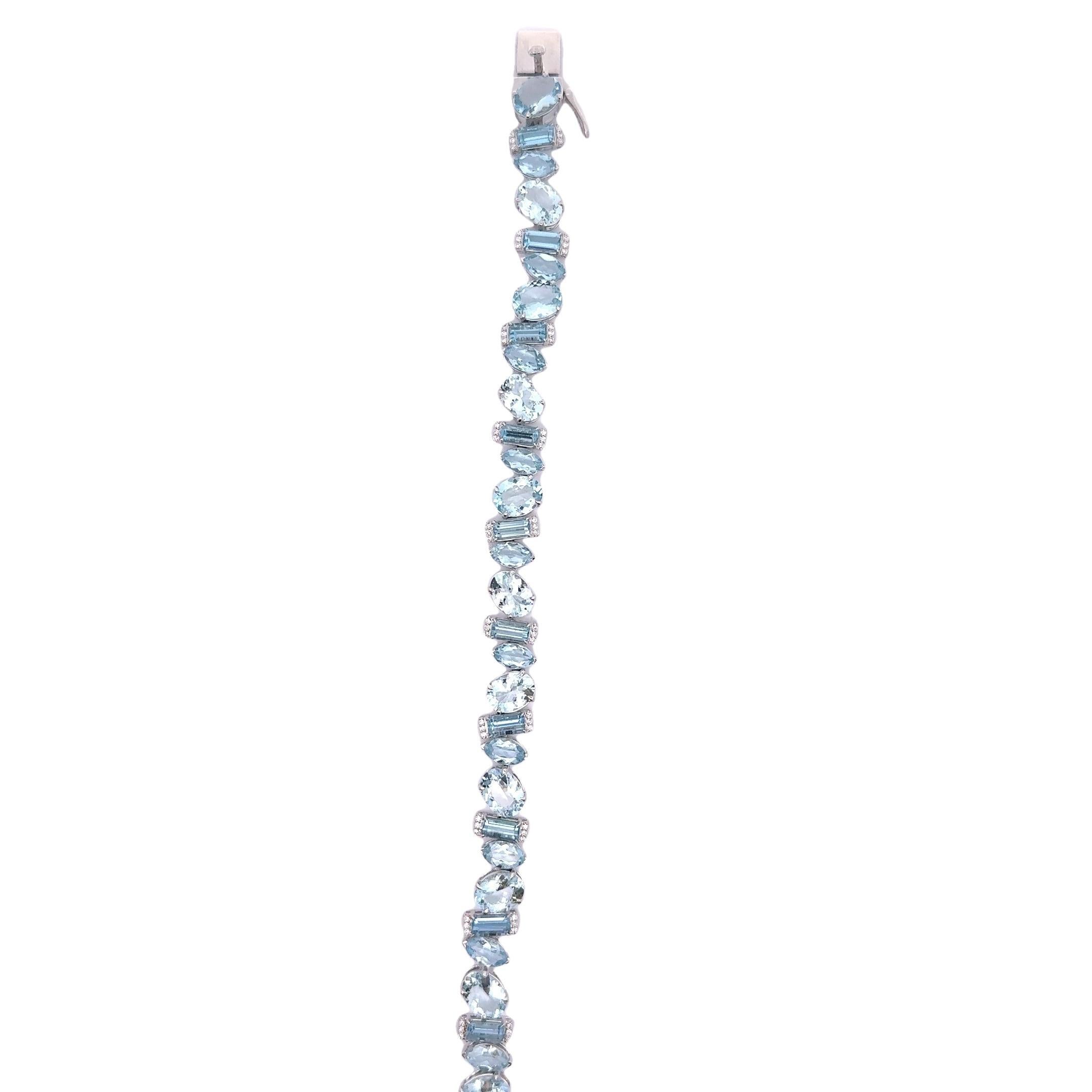 A contemporary line bracelet showcasing vibrant blue aquamarine stones. The aquamarines, weighing 21.60 carats, are cut in a mixed style, creating a dynamic visual effect. Complementing the aquamarines are round brilliant-cut white diamonds,