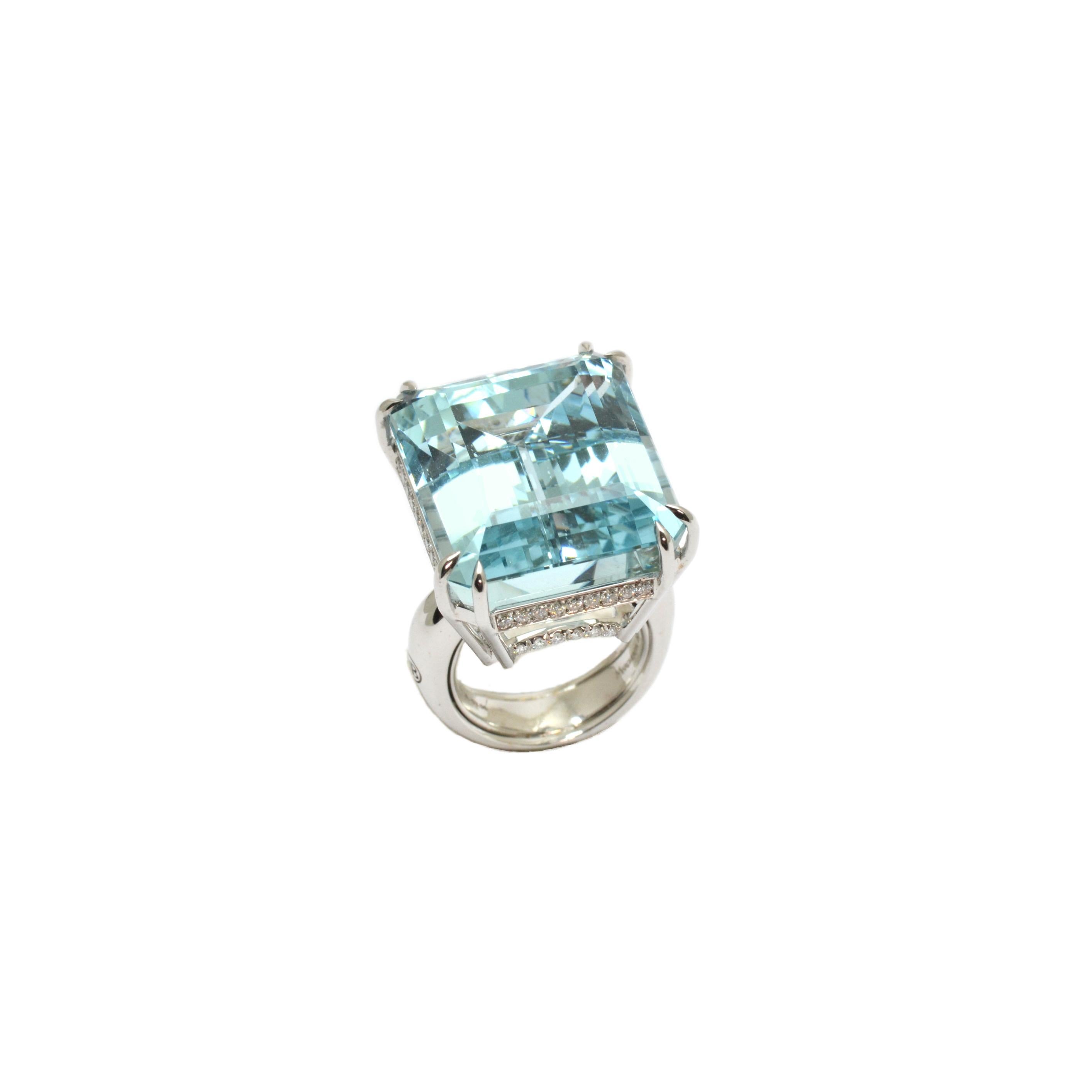 Centering an impressive 53.96 carat octagonal aquamarine, from Brazil, the ring designed and signed Margherita Burgener is a beautiful evergreen cocktail ring.
The shanks are well bombé shaped outside, inside it has a spring that help the ring to