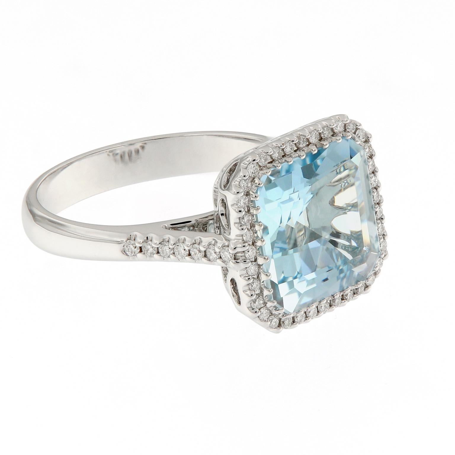 This gorgeous 18k white gold cocktail ring features a square step-cut aquamarine surrounded by a halo of pavé-set diamonds and beautifully balanced with diamonds running down the shank. The attention to detail on this ring is fantastic - the gallery