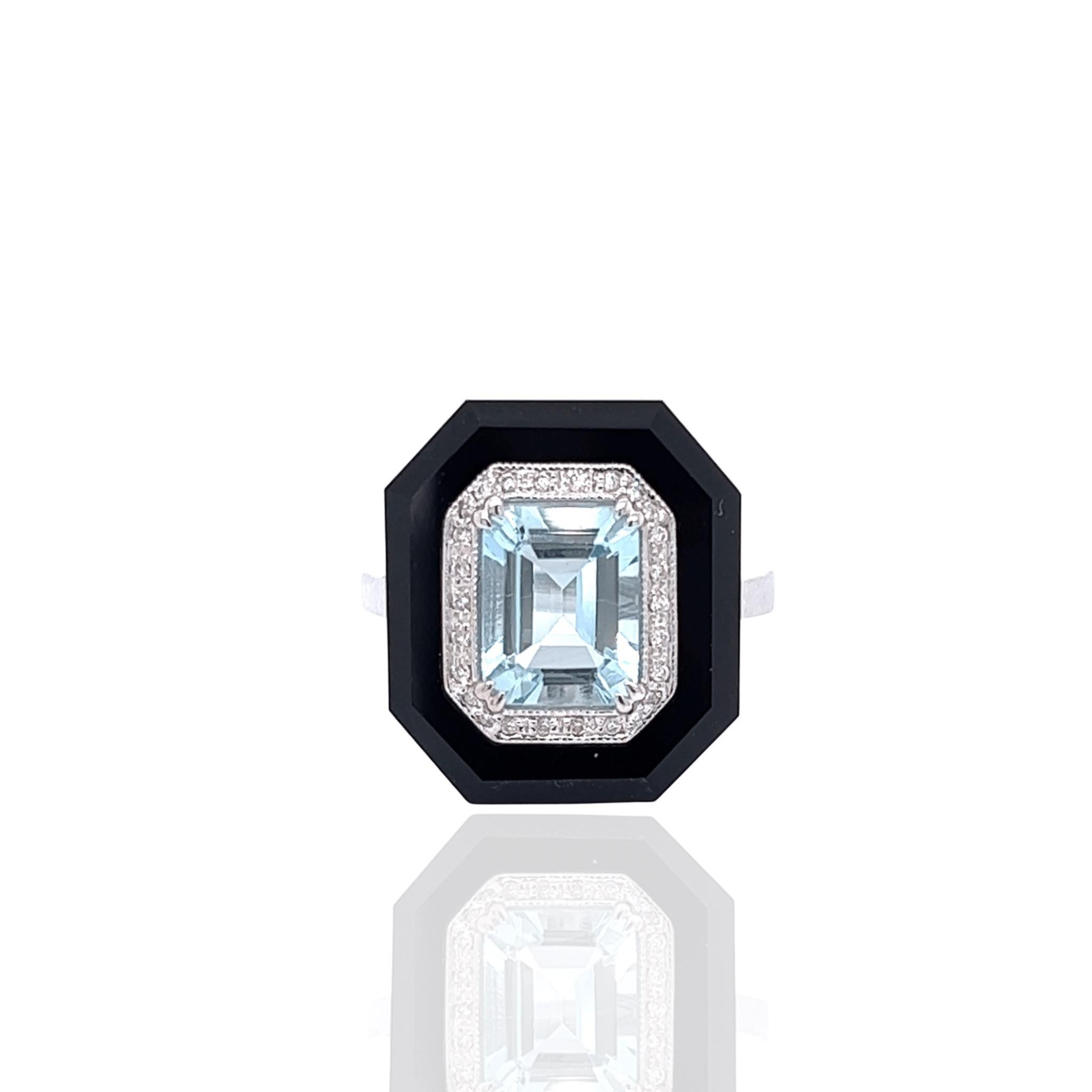 A TB Exclusive! The centerpiece of this ring is 1.9 carats of vivid aquamarine, surrounded by 2.4 carats of onyx and 0.12 carats of brilliant diamonds. All of the stones are set in 6.11 grams of 14k white gold. You'll love wearing this vintage