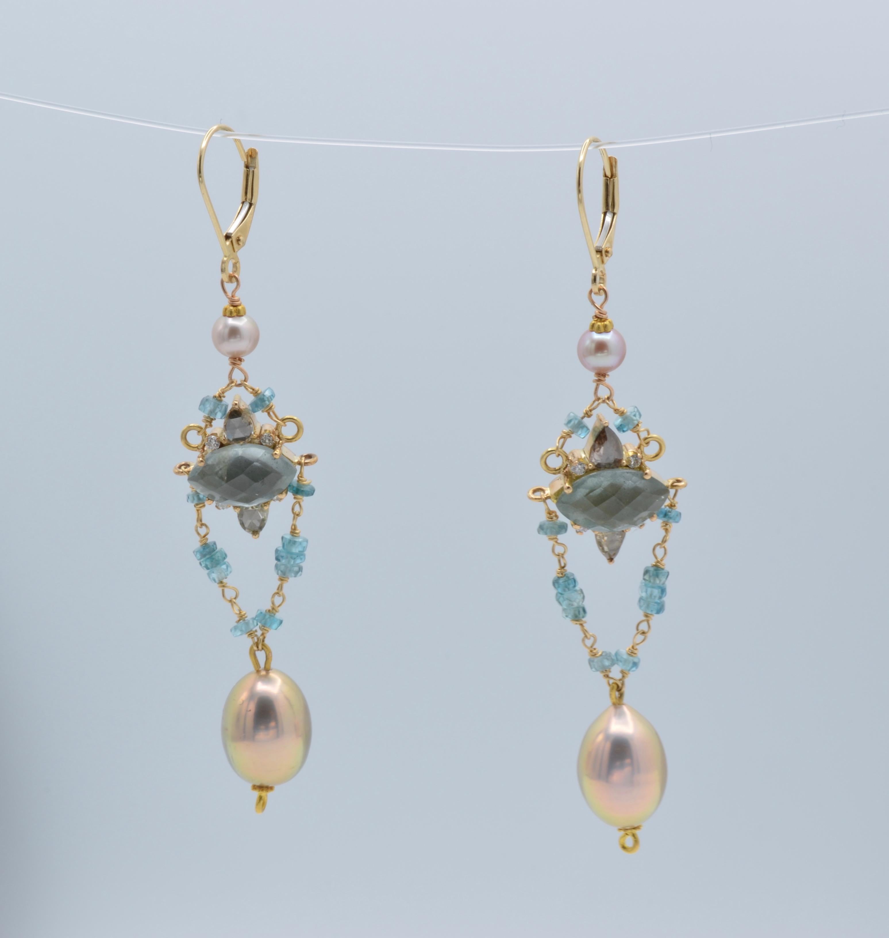 These beautiful statement earrings are an array of subtle color and light. The moss aquamarine and diamond centers are delicately framed in apatite beads and natural pink pearls.