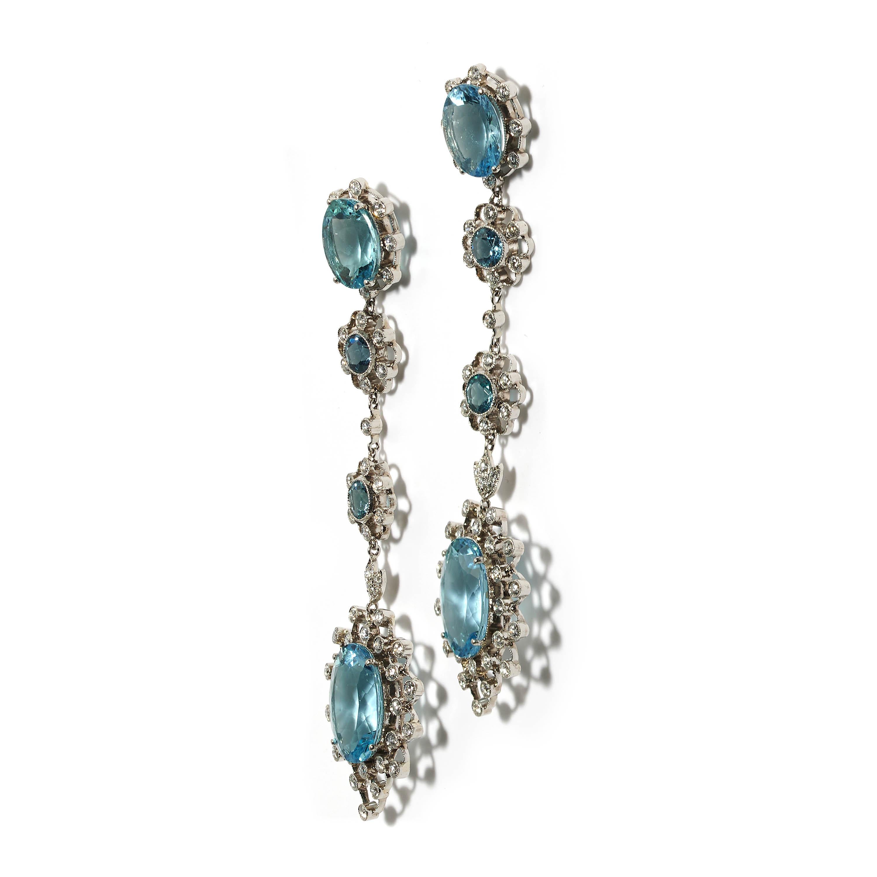 A modern pair of drop earrings consisting of four separate aquamarine and diamond cluster sections, with an estimated total weight of 17.37 carats of round and oval-cut aquamarines, and an estimated total weight of 1.79 carats of round,