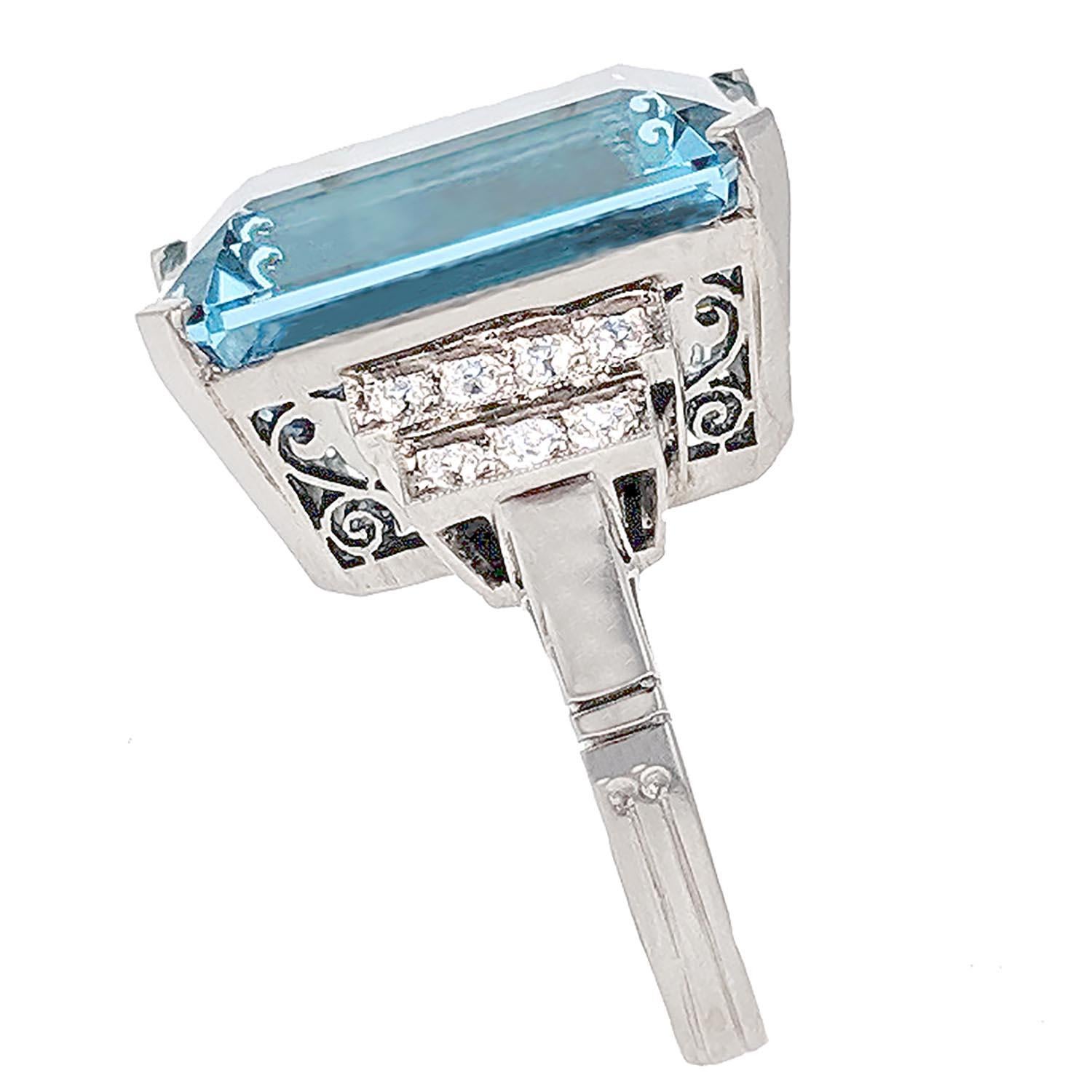 With an emerald-cut aquamarine of 18.84 carats, flanked by stepped segments of old-European cut diamonds, mounted in platinum. Size 6.75.

The aquamarine is clean with a nice and even saturated color and a good polish.