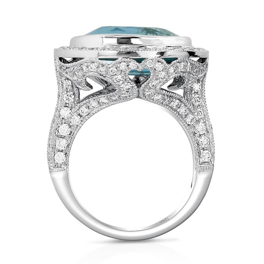 Like an alpine lake surrounded by white flowers, an elongated aquamarine is set into this diamond studded ring. Elegant diamond scrollwork adds a delicate finish to a solid design aesthetic.

Oval-Shaped Aquamarine: 6.47cts.
Round Brilliant-Cut