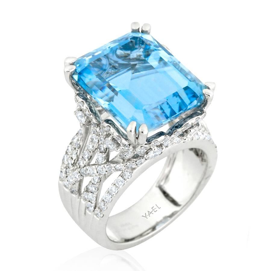 This majestic ring features a sizeable aquamarine held high above a ring formed from diamond swirls and scrollwork; the open design creates a light and airy look belying the ring’s resplendent size. 

Aquamarine: 13.70cts.
Round Brilliant-Cut