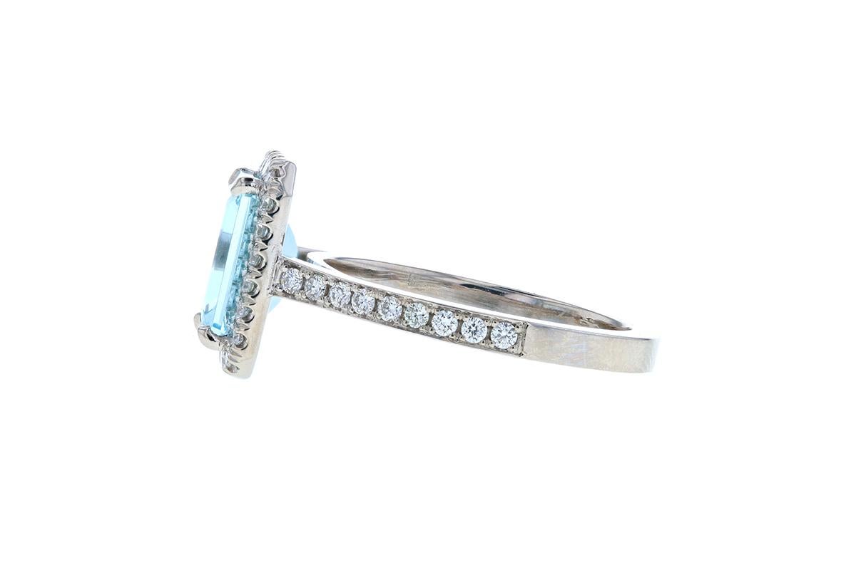 This stunning Aquamarine Diamond Engagement Ring with Diamond Halo has an almost 2 carat center aquamarine and is surrounded by a diamond halo. With diamond pave on the shank and a square shank, this stunning aquamarine and diamond halo engagement