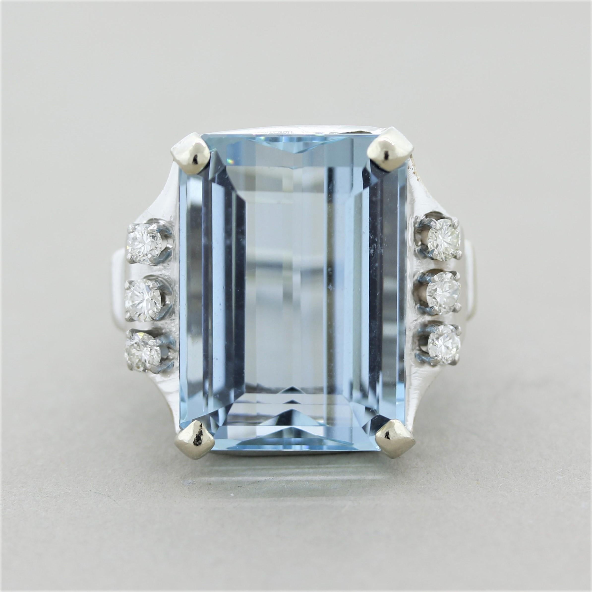 A stunning cocktail ring featuring a 19-carat rectangular aquamarine. It has a bright and pleasing sea-blue color and is free of any eye-visible inclusions which allows the stones natural color and brightness to be showcased. It is accented by 6