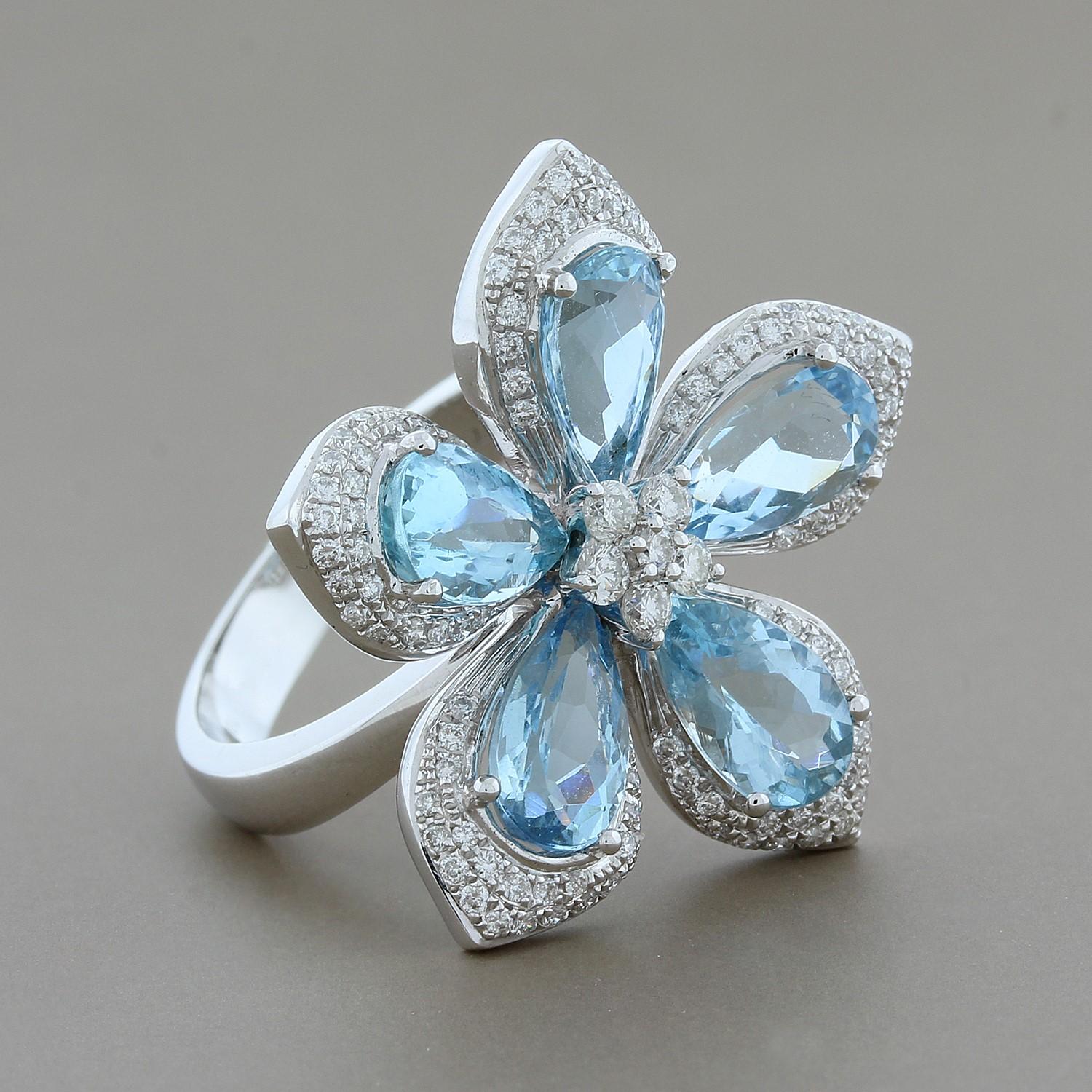 A feminine five petal flower comprised of 4.28 carats of pear shape aquamarines.  The aquamarines are all perfectly matching in blue color. Round cut diamonds sit in the center of the ring to create the flower bud and pave diamonds halo each pear