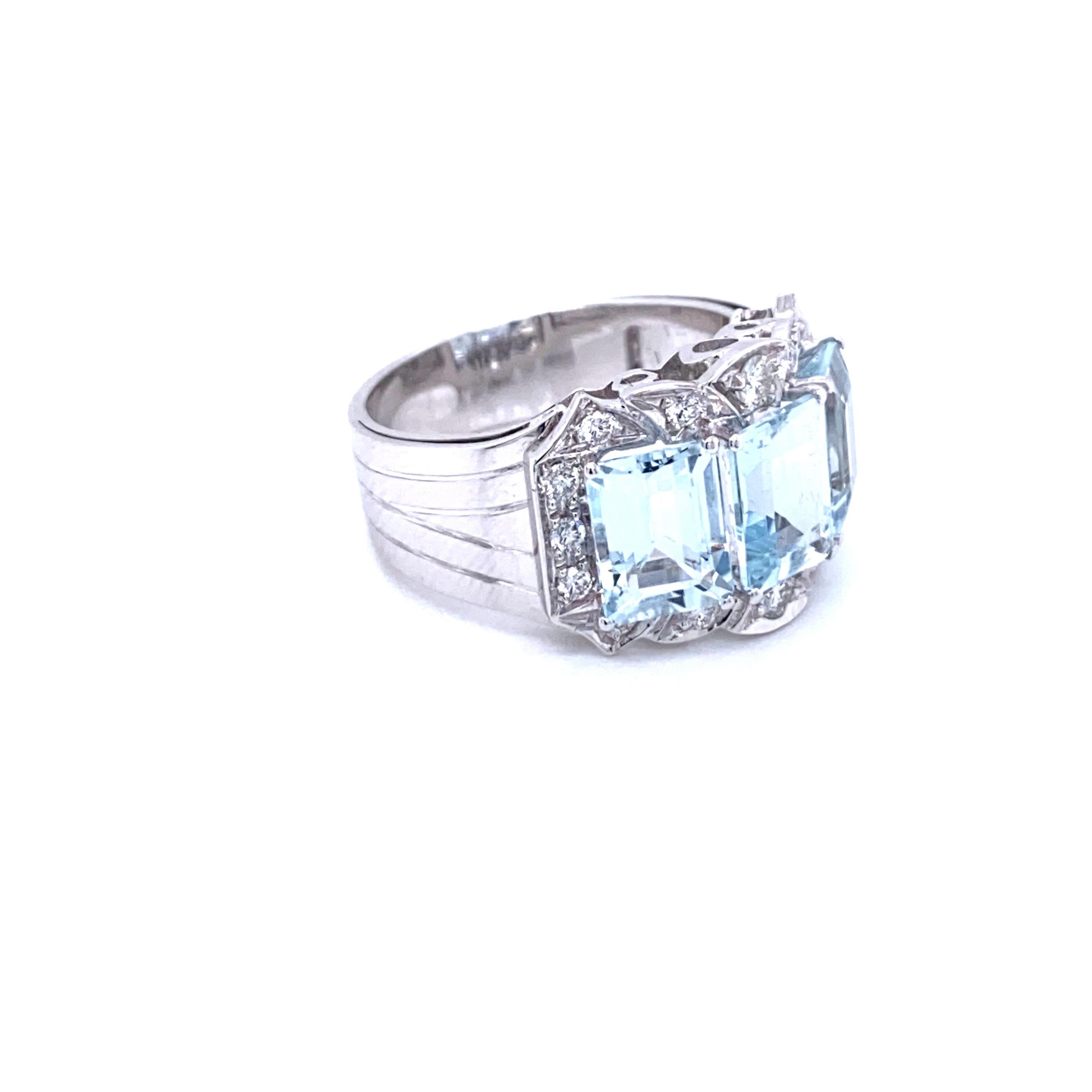 This Art Deco style 14k gold band ring features Three beautiful natural emerald cut Aquamarine, total weight 4 carats, and surrounded by Round Brilliant cut diamond weighing 0.50 cts graded G color VvS clarity. Handmade in Italy,