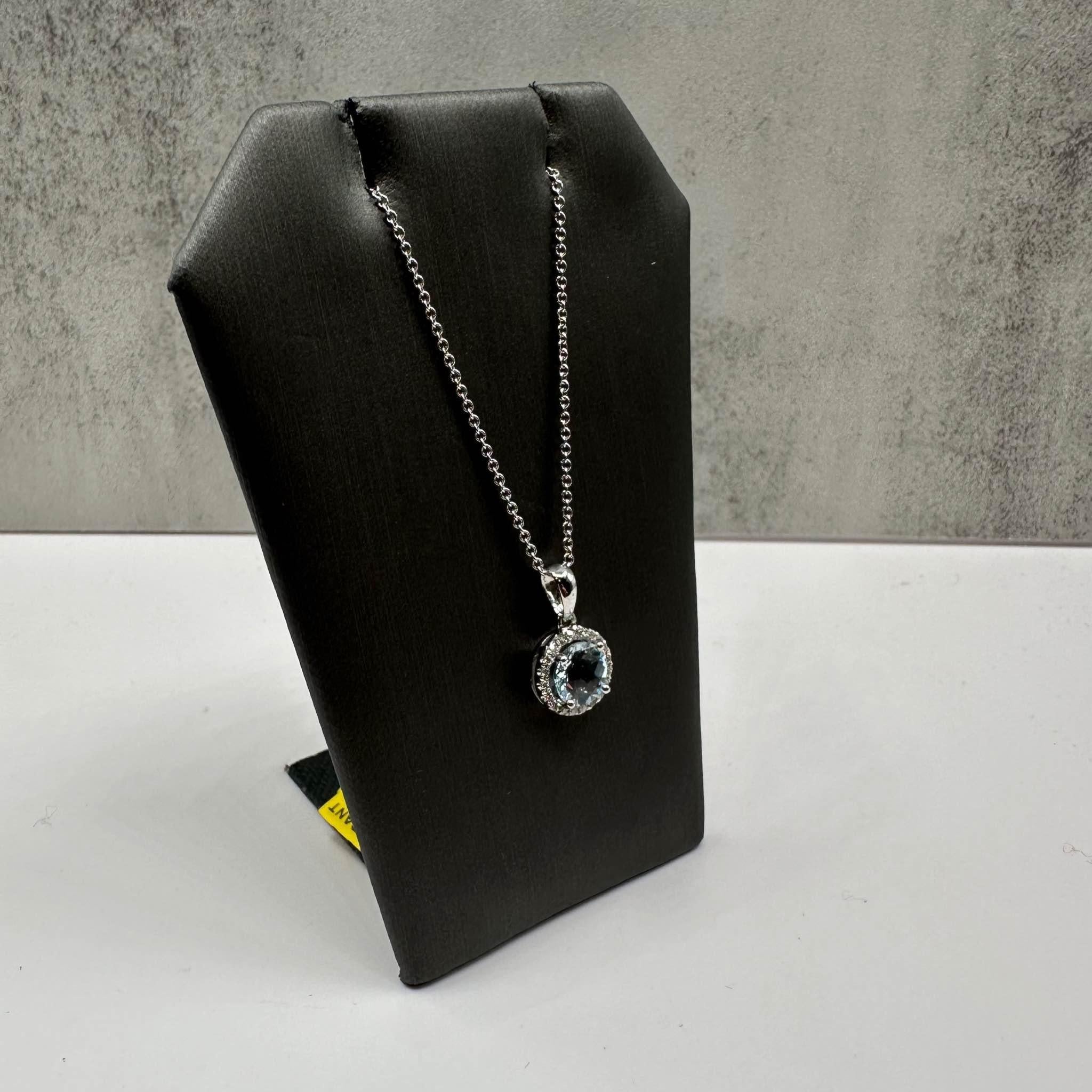 This stunning Aquamarine and Diamond Necklace in 14kt white gold features a 6.9mm round aquamarine, complemented by 0.10ctw of natural GH SI round diamonds for a brilliant contrast. The 18-inch chain is perfect for layering or wearing alone, and the