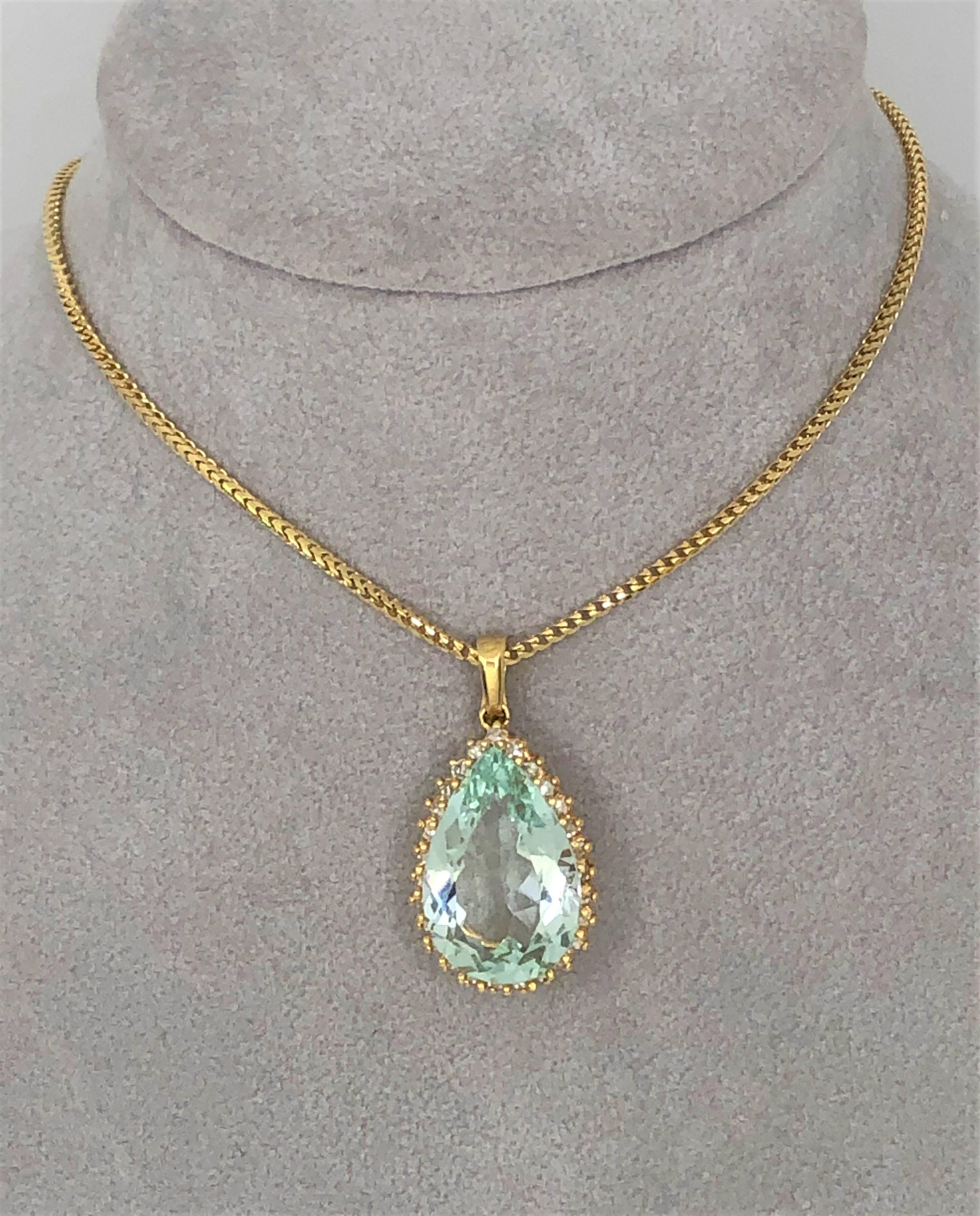 This is stunning!  The pear shaped aquamarine and the diamonds sparkle!
14 karat yellow mounting
Pear shape aquamarine approximately 20mm x 14mm x 8mm surrounded by diamonds, approximately 10 carats
27 single cut round diamonds, VS-SI clarity and