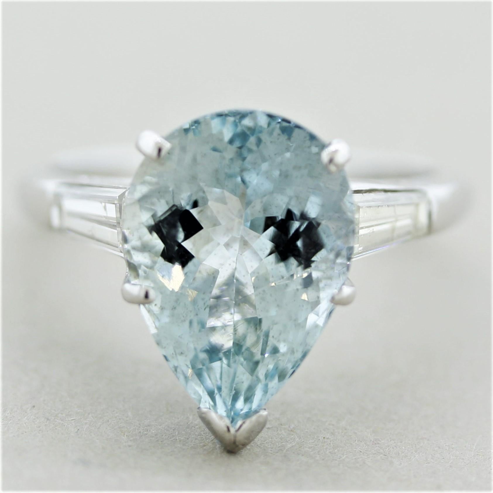 A classic 3-stone ring featuring a 5.46 carat pear-shape aquamarine. It has a lovely bright sea-blue color and is accented by 2 baguette-cut diamonds set on its sides and weighing a total of 0.40 carats. Hand-fabricated in platinum and ready to be